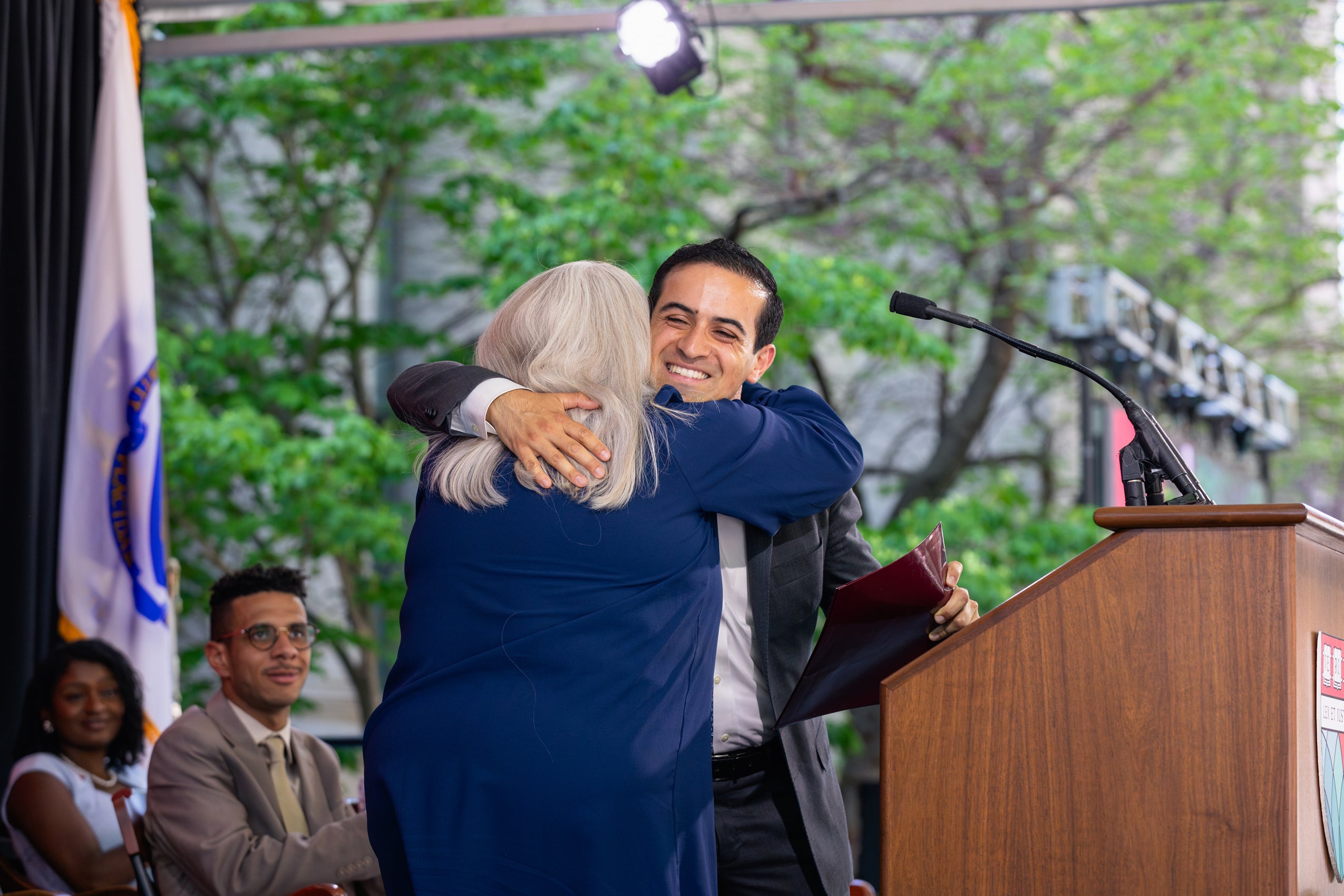 people hugging on stage