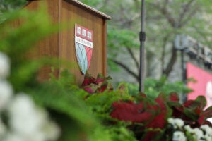 HLS shield on a podium surrounded by flowers