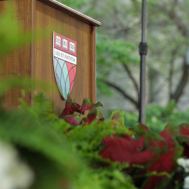HLS shield on a podium surrounded by flowers