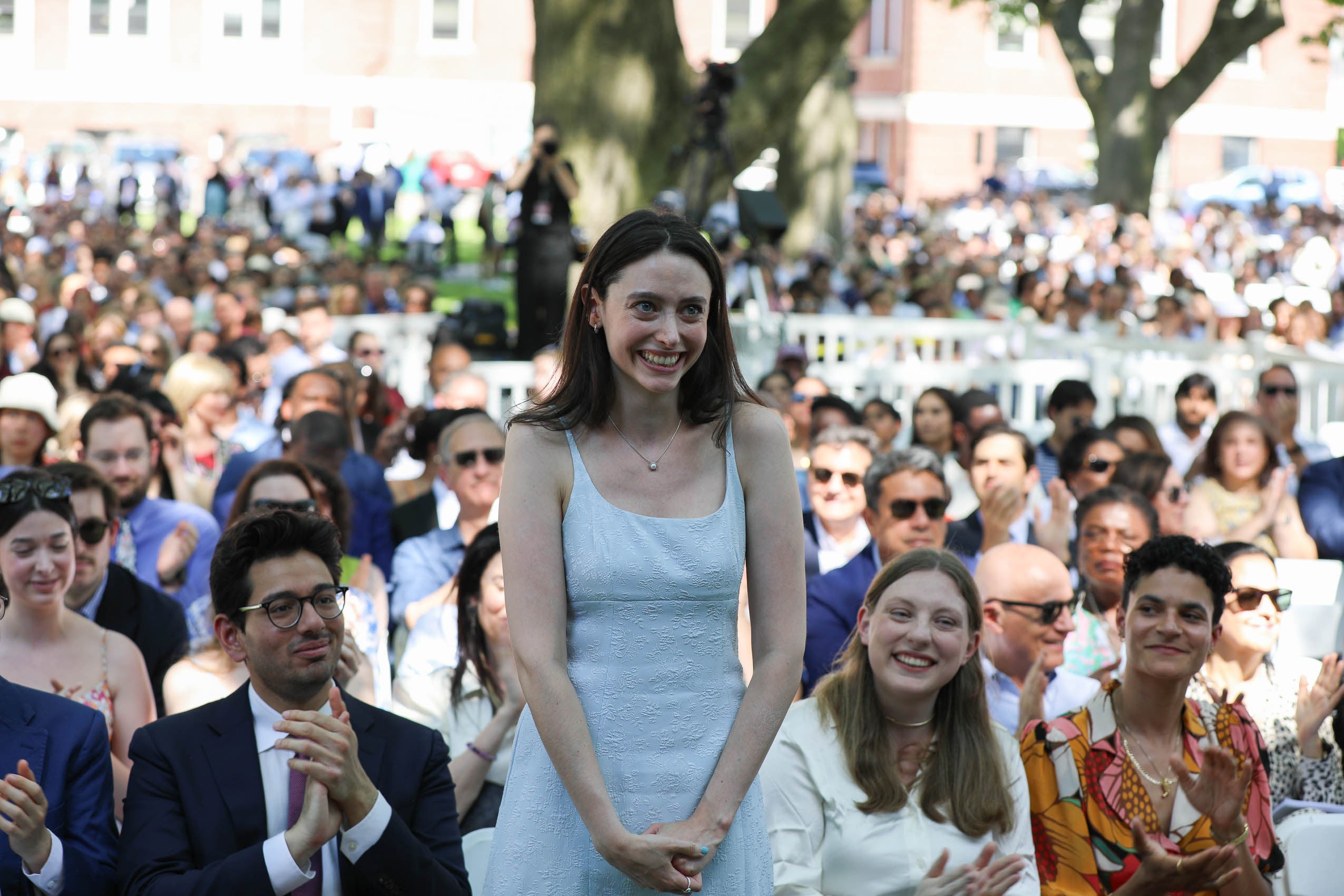 A woman standing and smiling