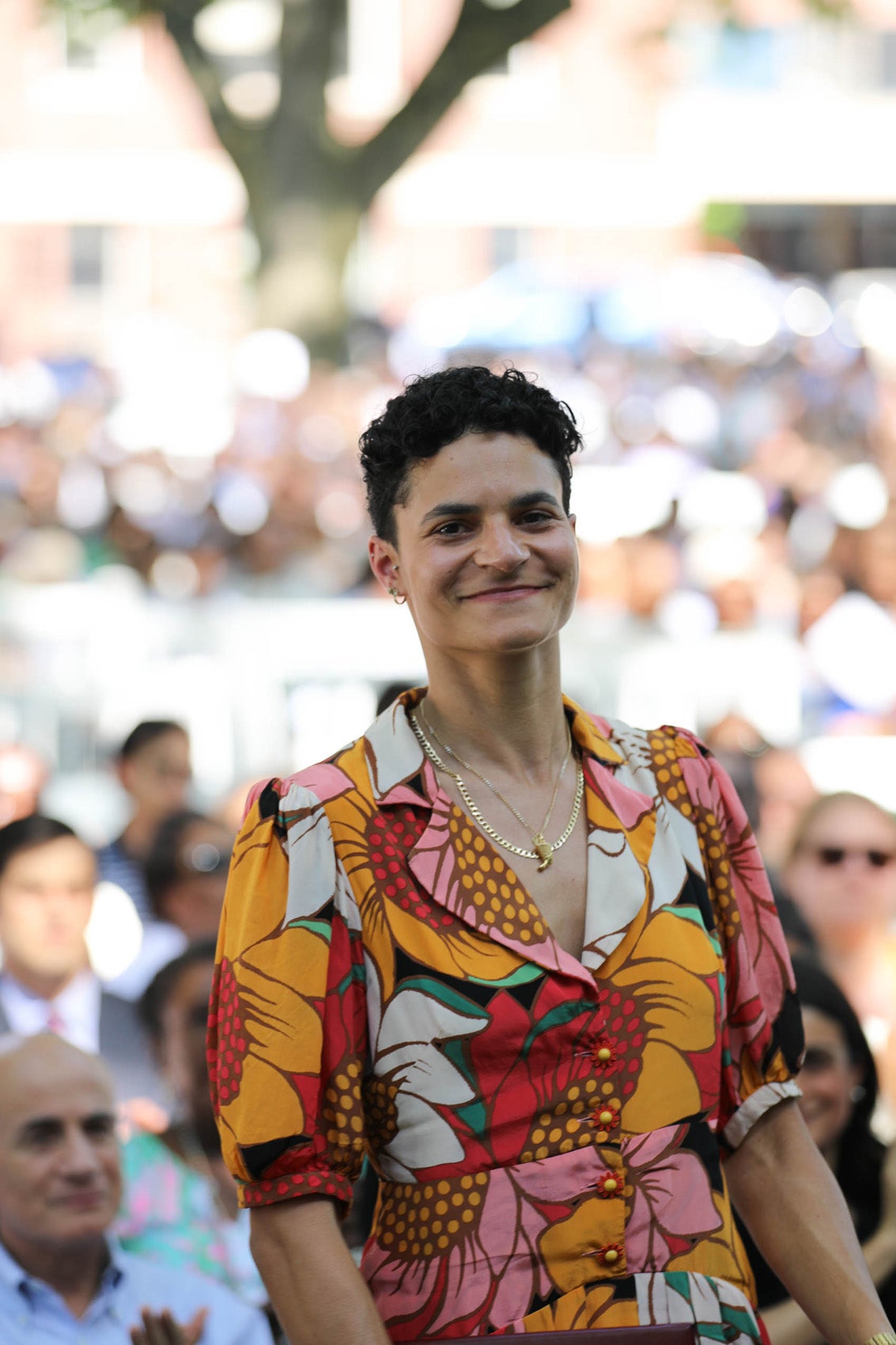 A woman standing and smiling