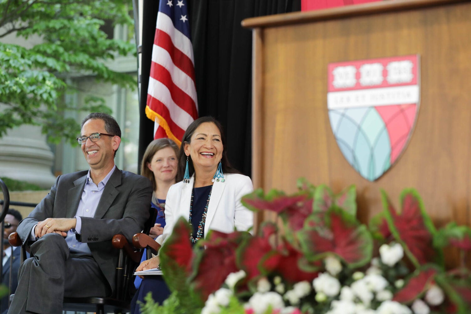 Deb Haaland and John Goldberg sitting on stage