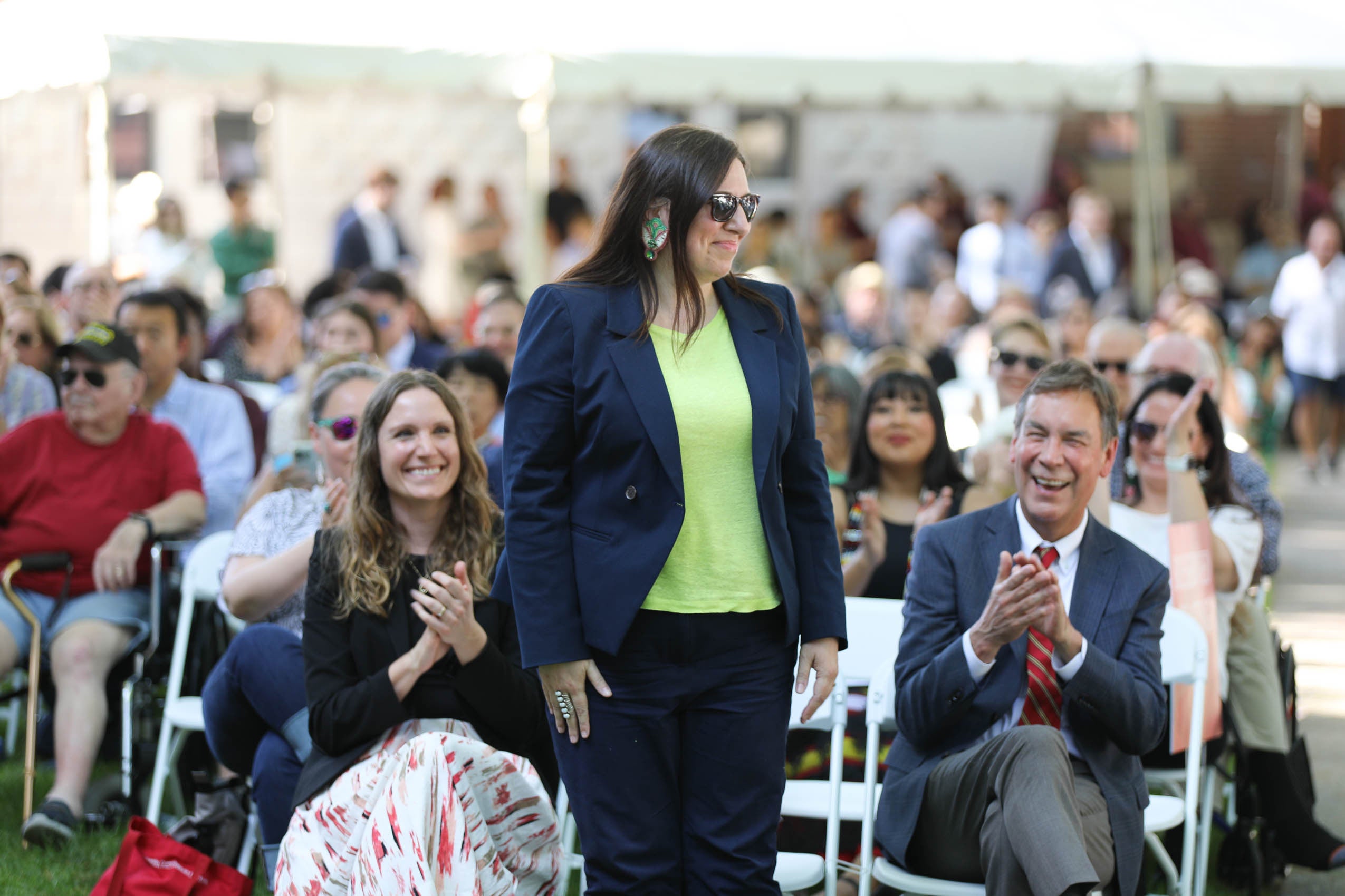 A woman standing in the audeince