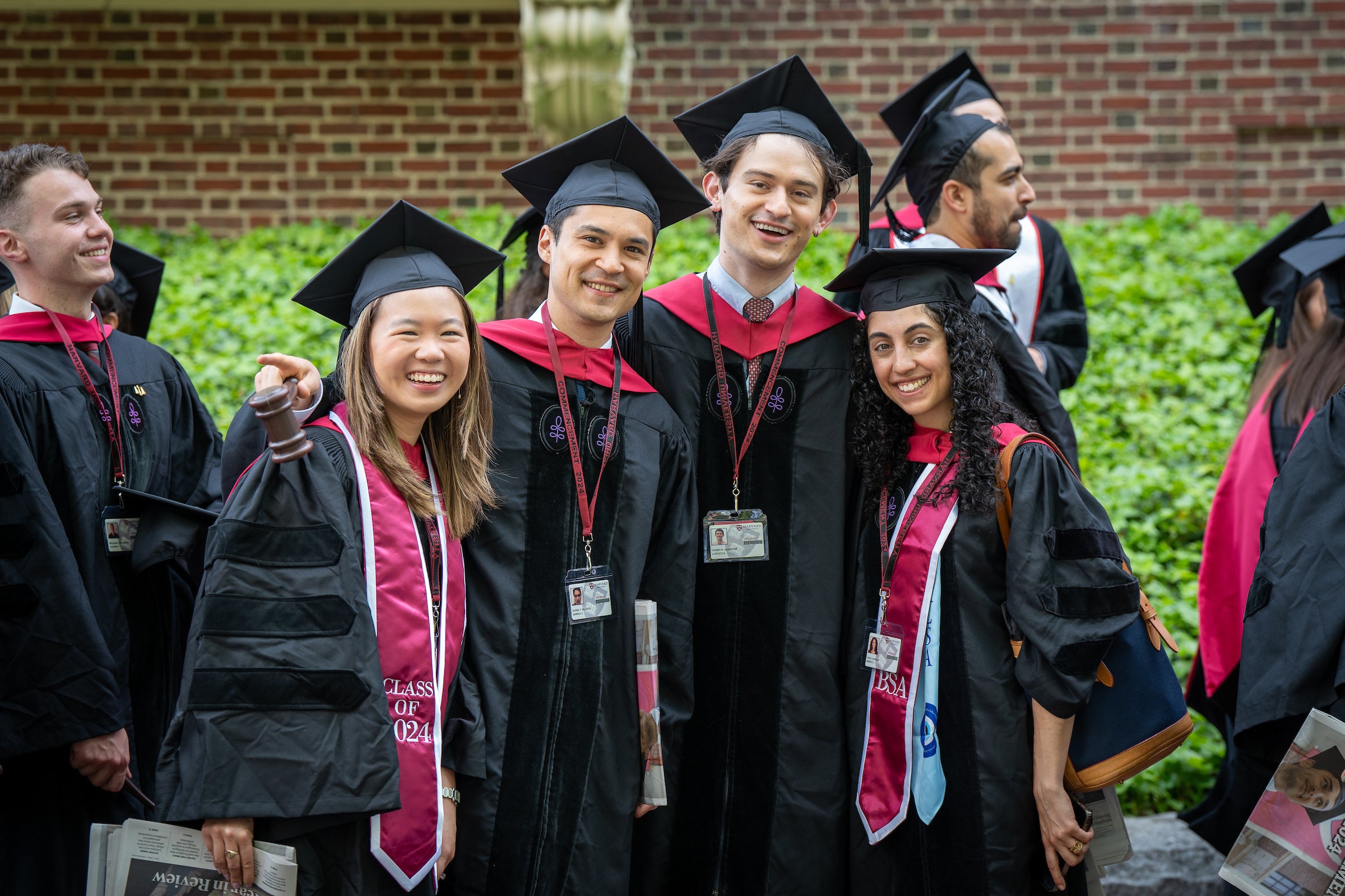 Four graduating students smiling