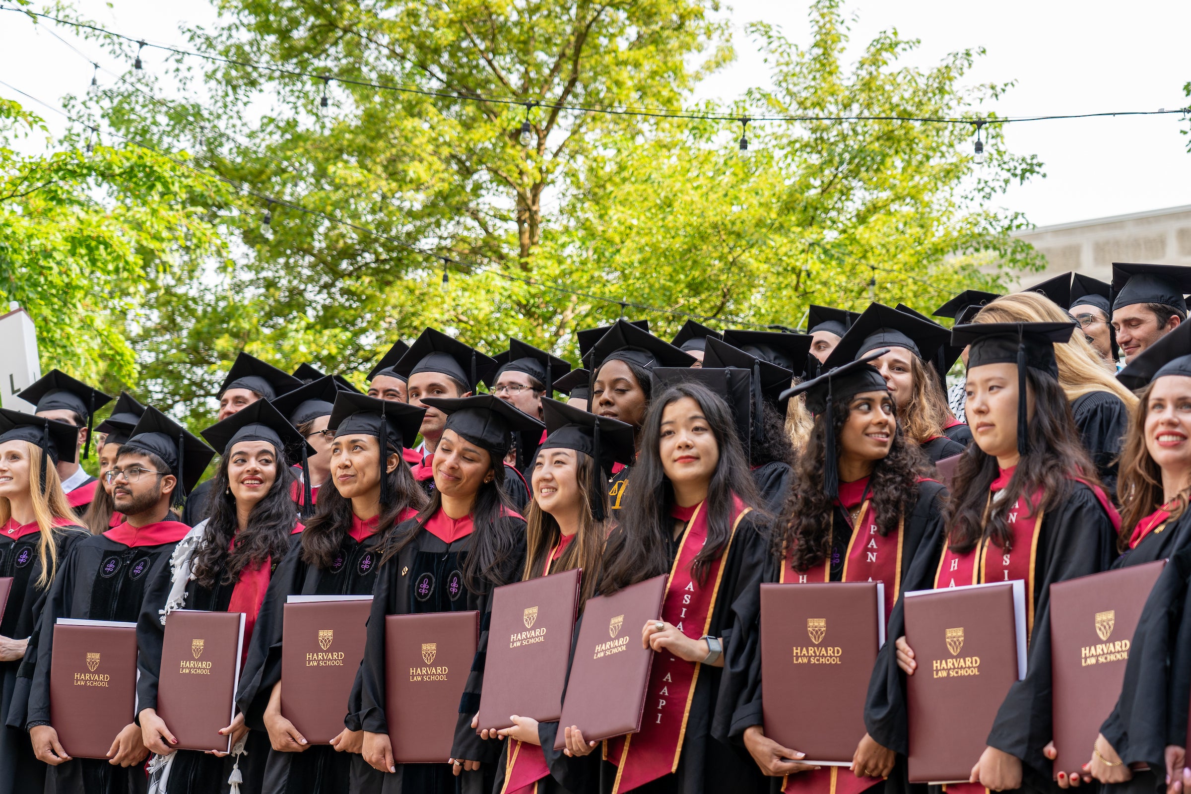 Graduates gathered together with their diplomas for a photo