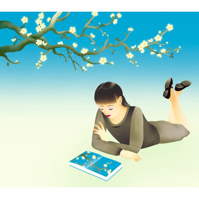 An illustration of A blossoming tree sits above a young woman who is looking at a book reflecting the tree