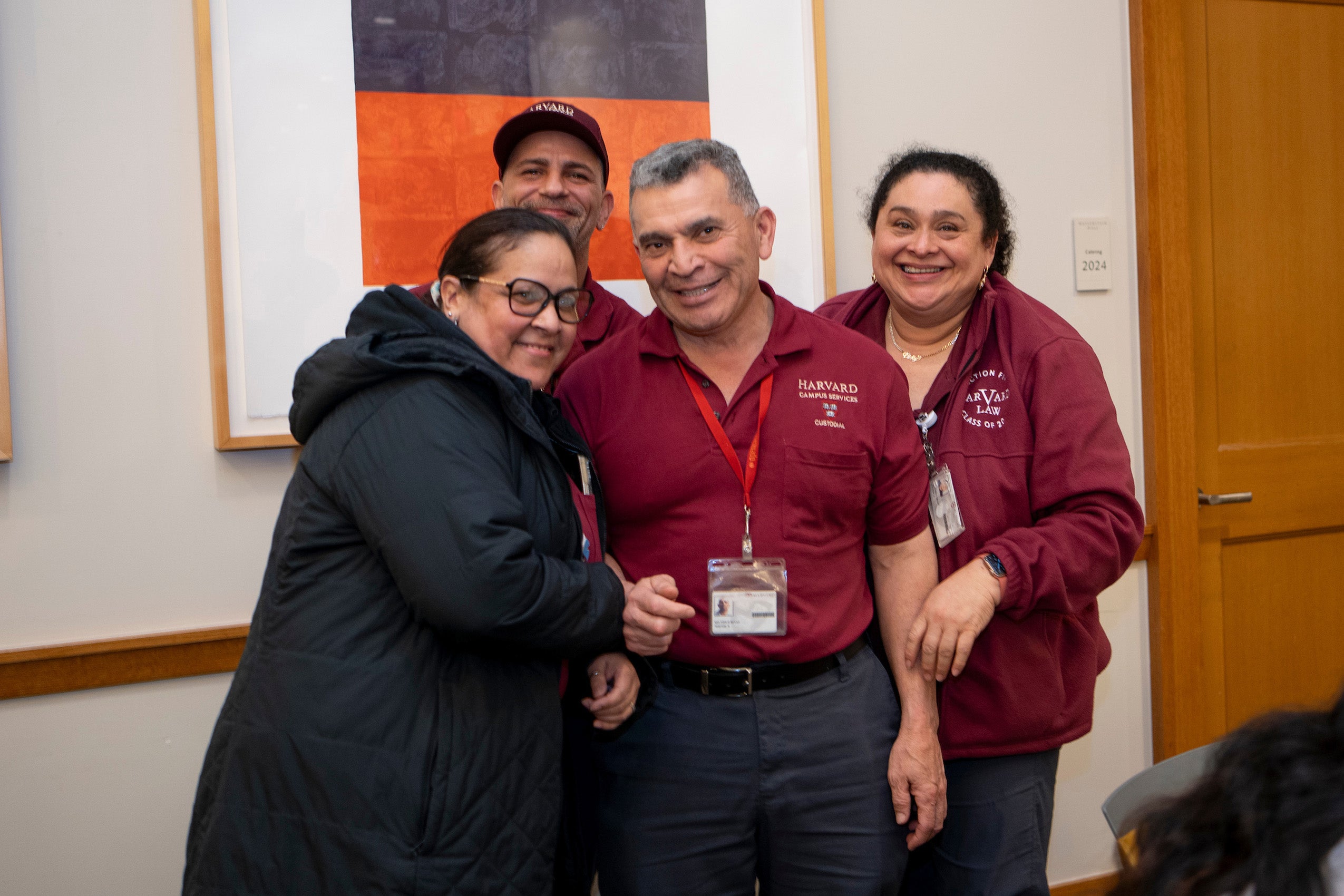 Four people pose for the camera at an event.