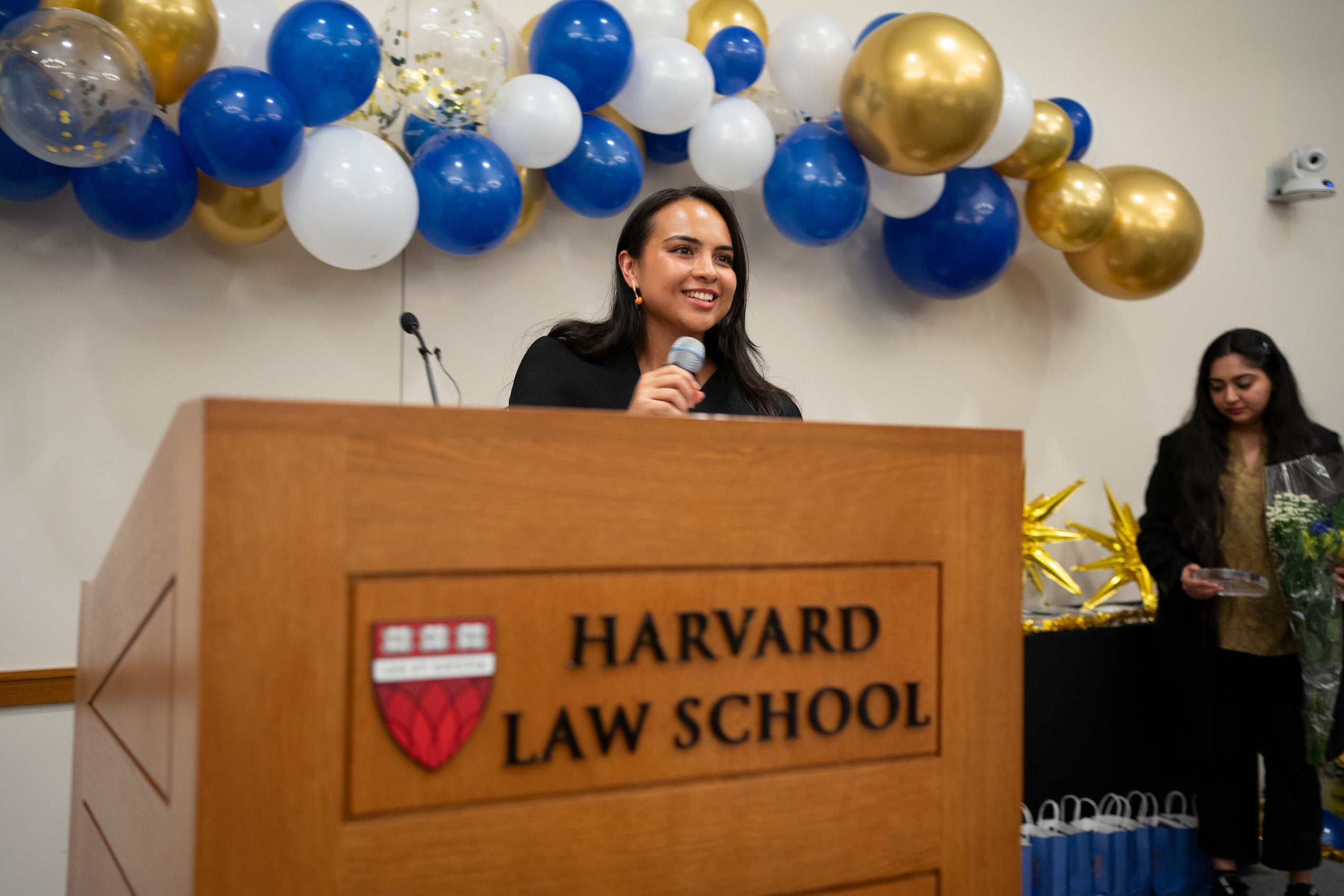 A woman speaks at the front of the room