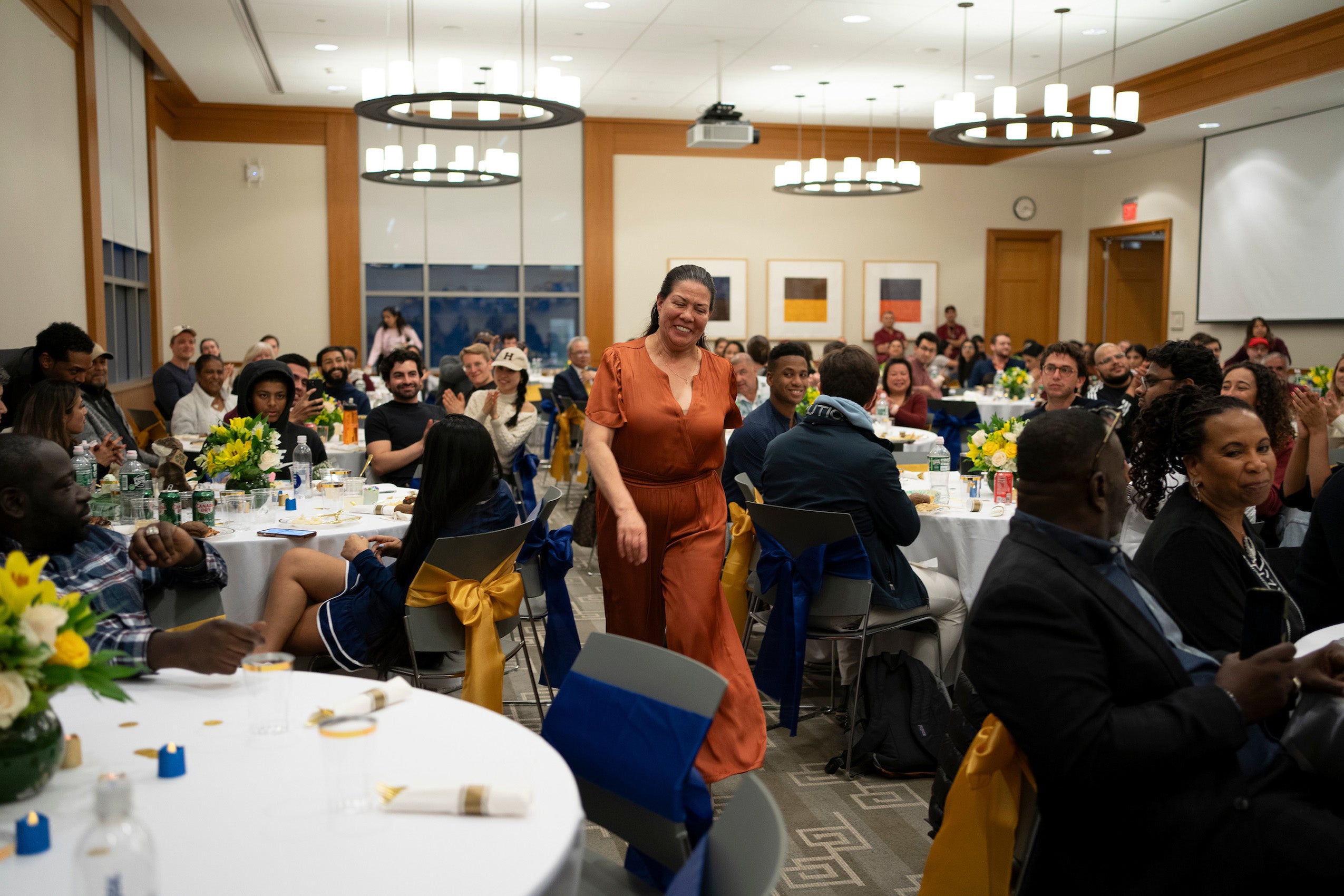 A woman to the front of the room at an event to