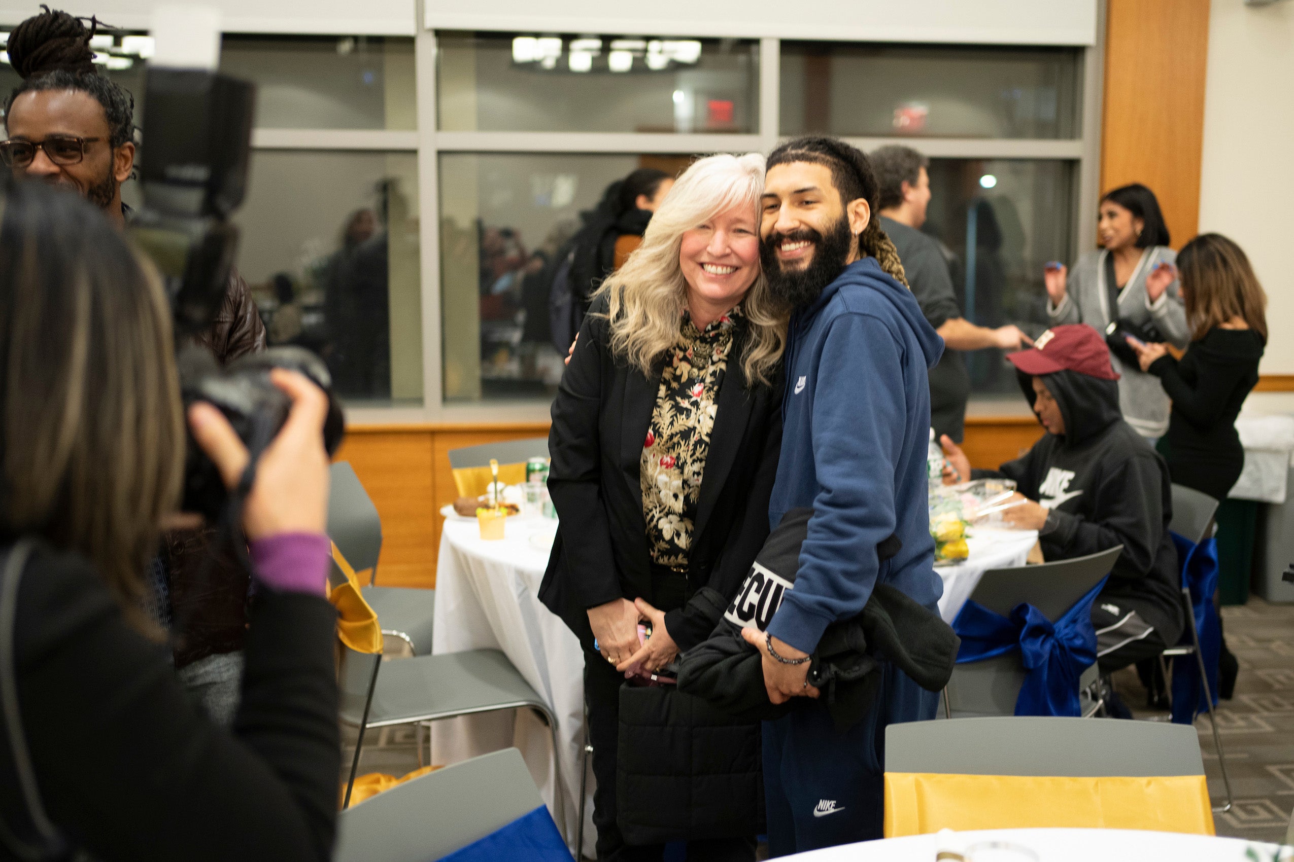 Two people posing for the camera at an event