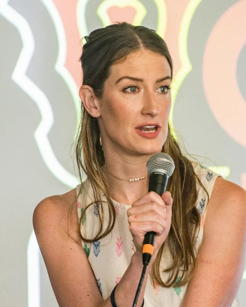 a woman speaking into a microphone