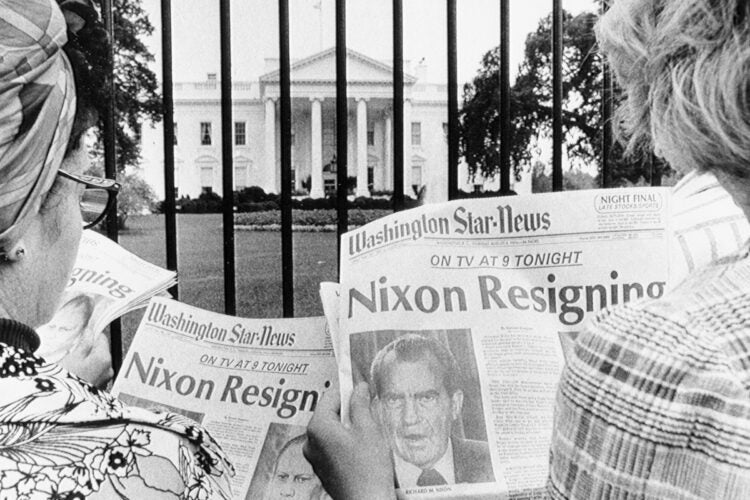 People reading newspapers with 