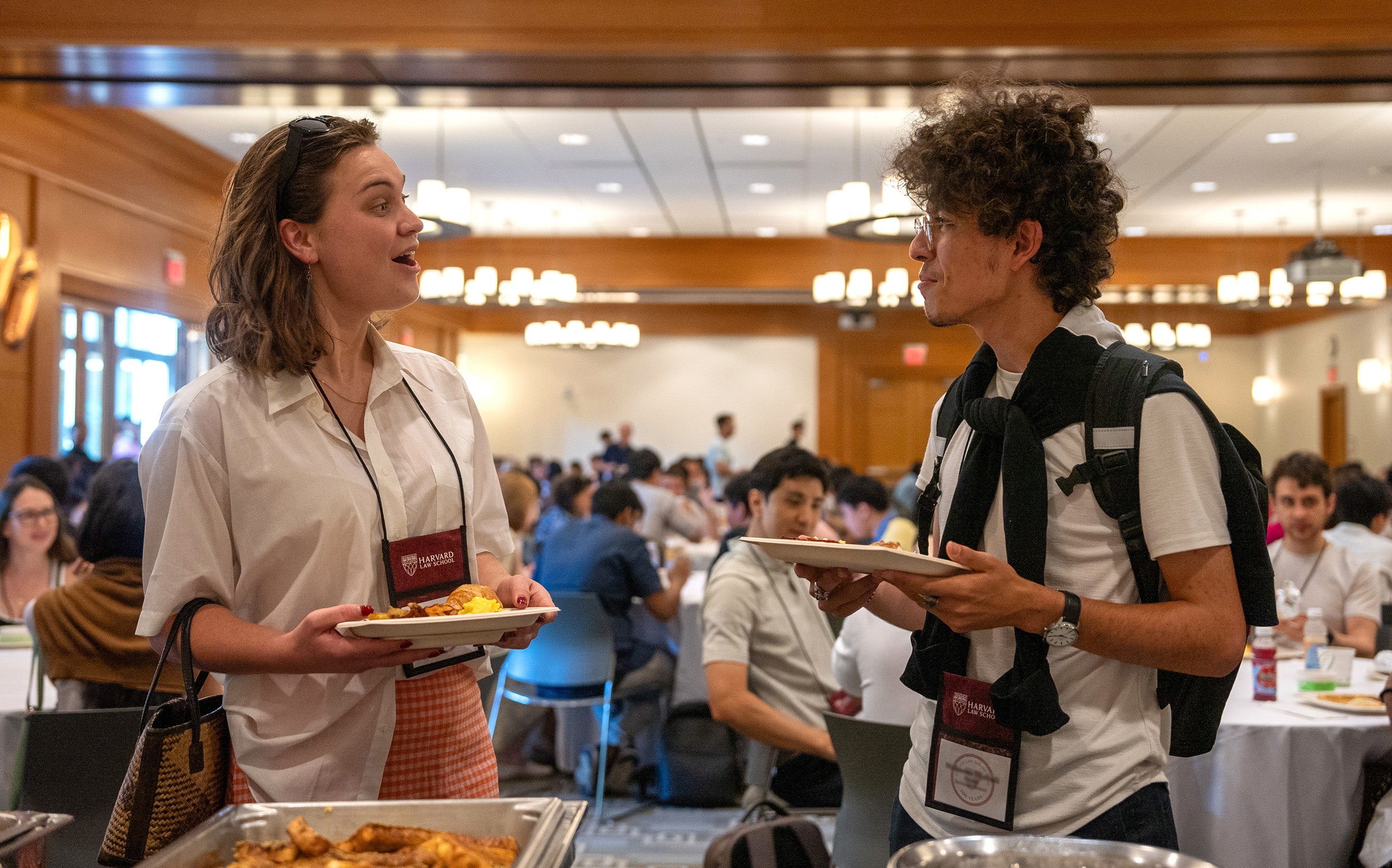 A man and a woman talking to each other at an orientation event.