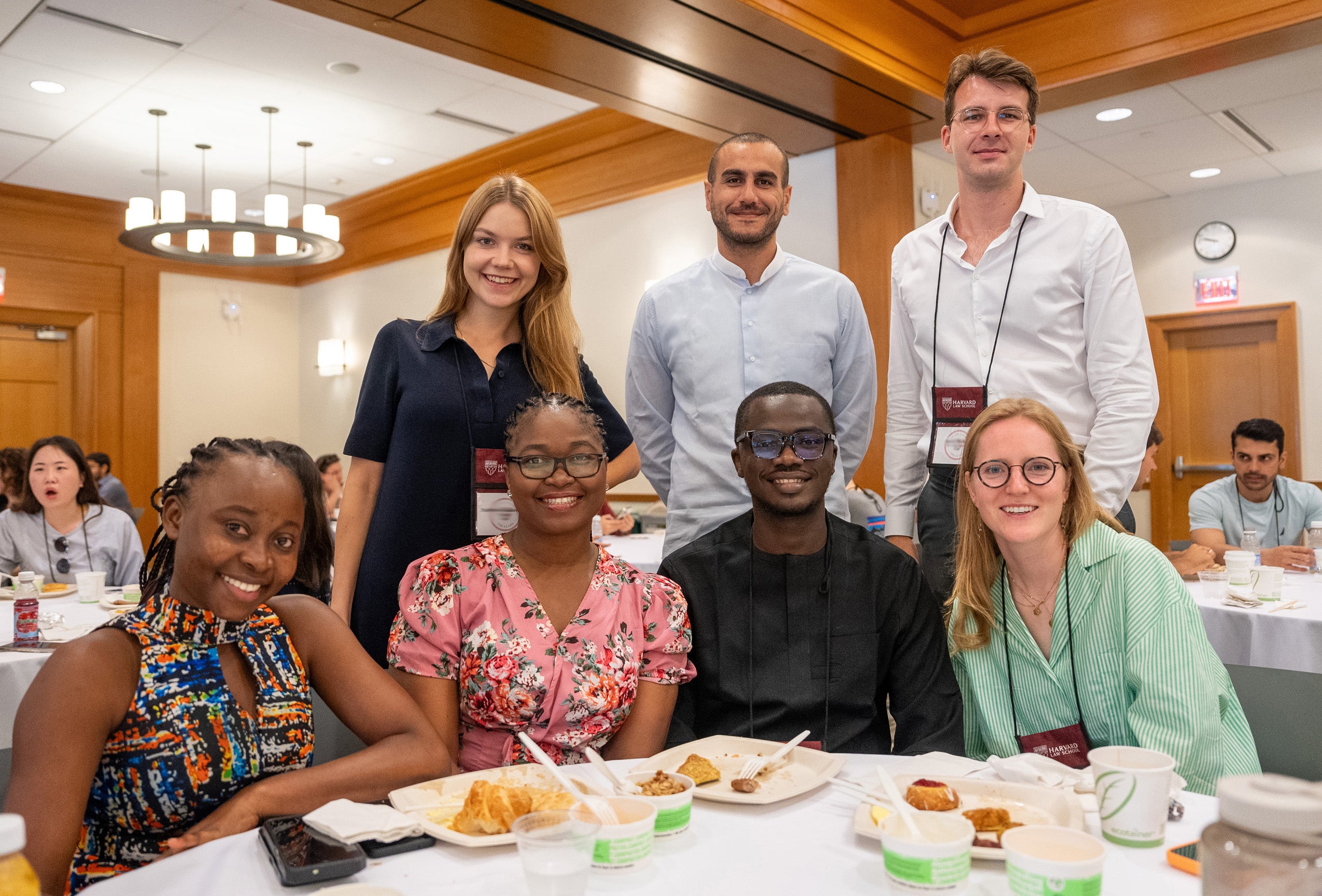 A group of students pose at a table following a breakfast at orientation