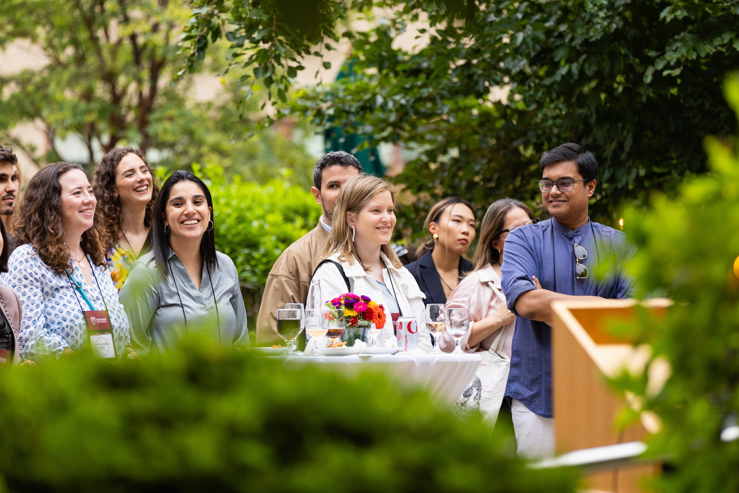 A group of students listening to a speaker at an orientation event.