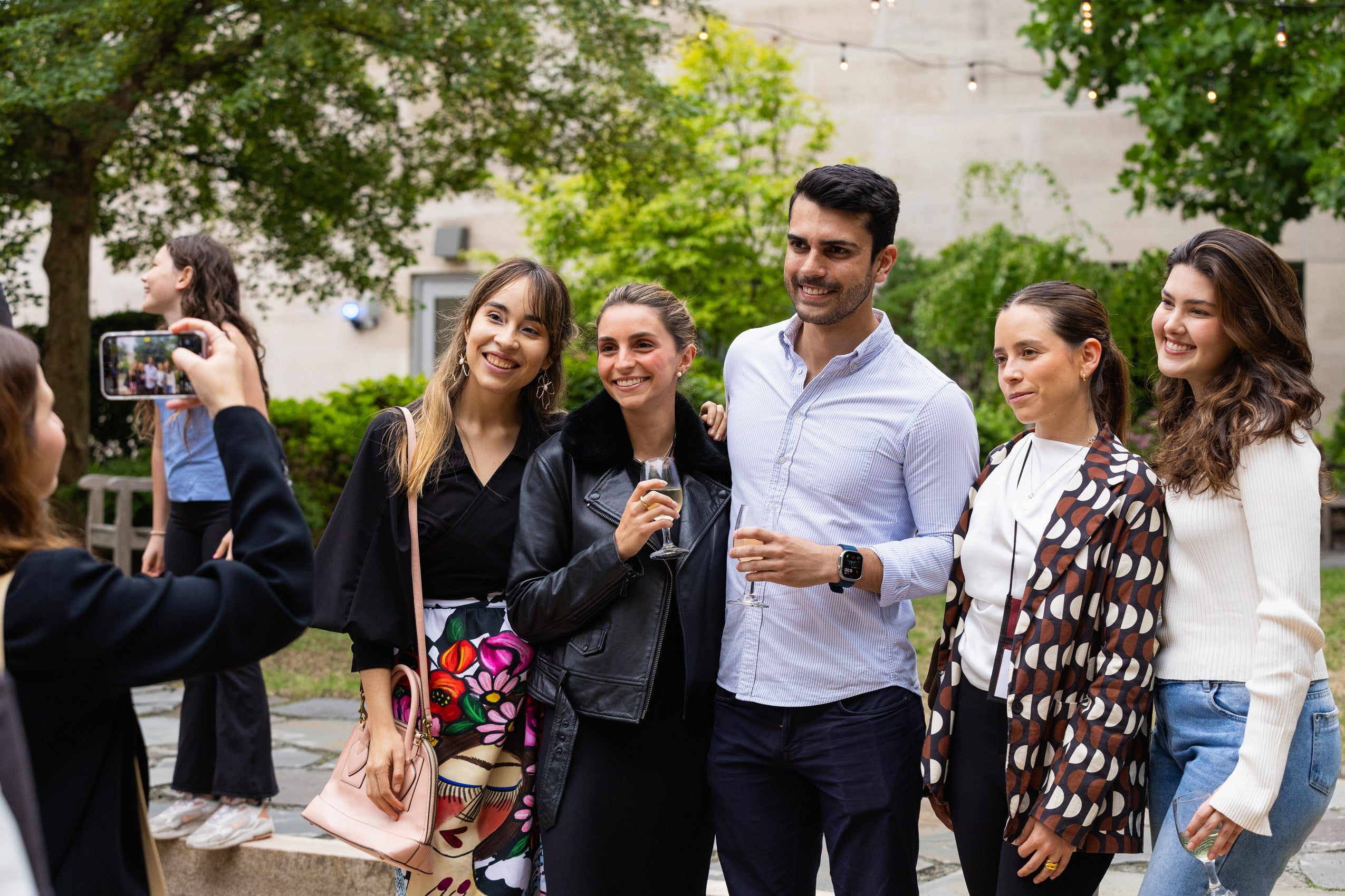 A group of students posing while another student takes their photo.