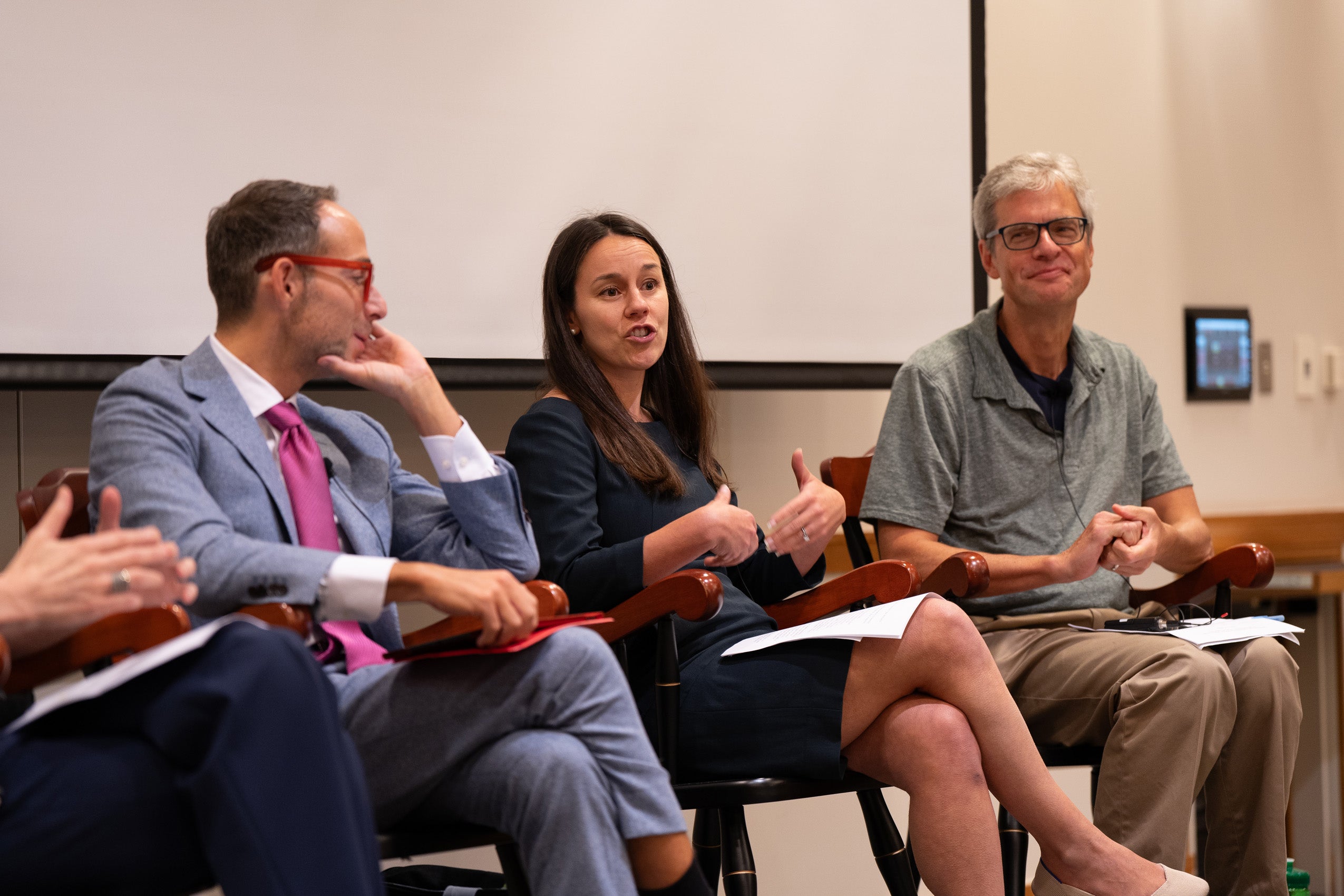Three faculty speak to an audience of students during day ) orientation.