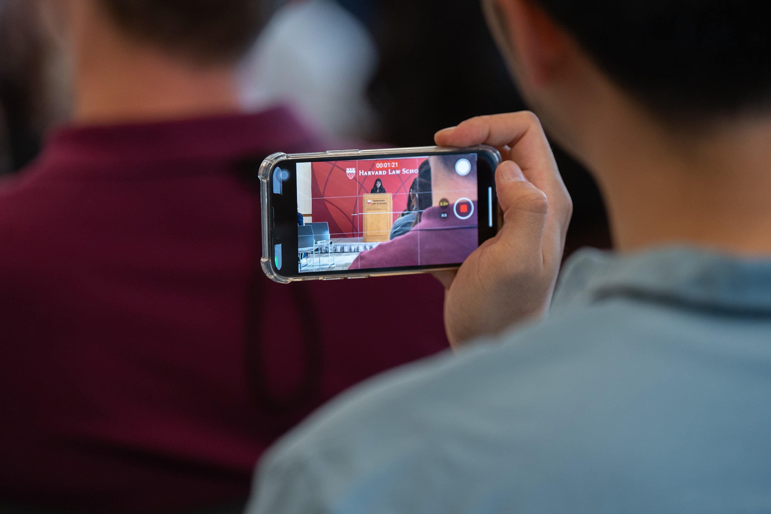 A cell phone captures a video of remarks during orientation.