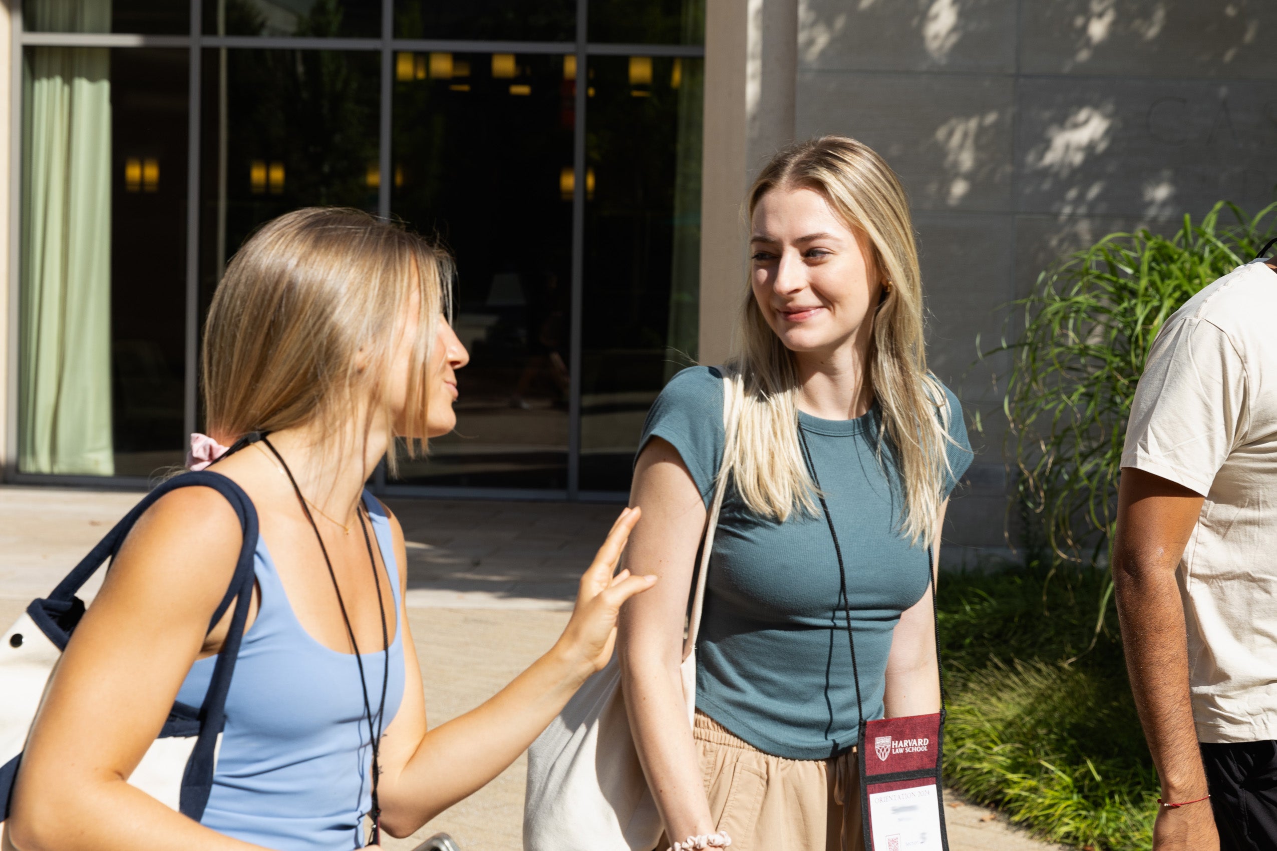 Two women walking across campus during orientation.