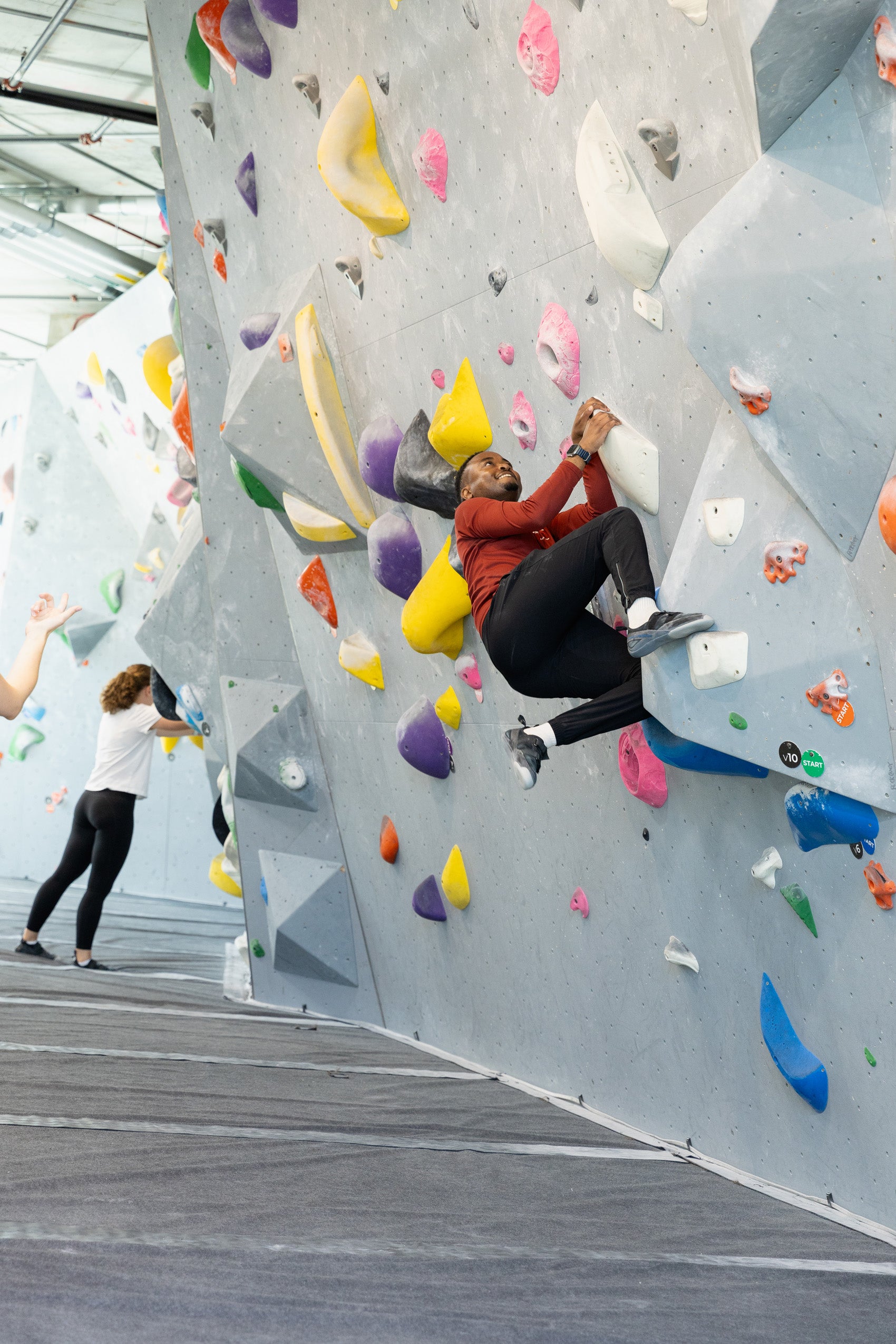 Students rock climbing at a climbing gym.
