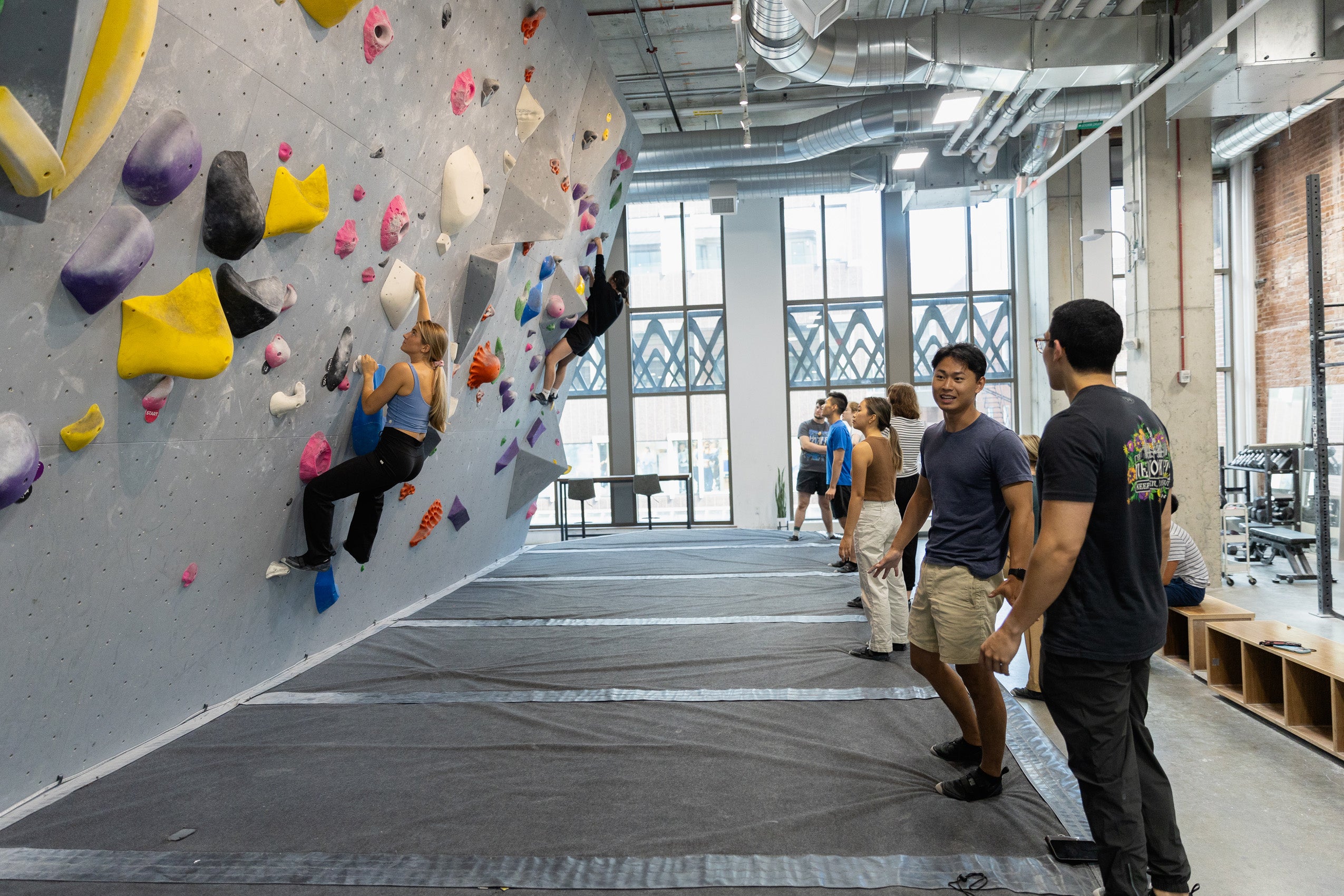 Students rock climbing at a climbing gym.