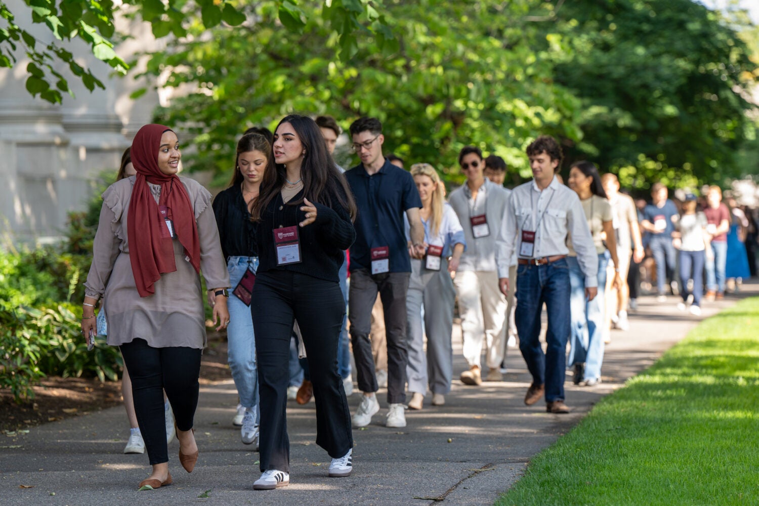 A large group of students walking on campus during orientation activities
