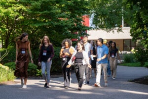 A group of students walking along a path on campus.