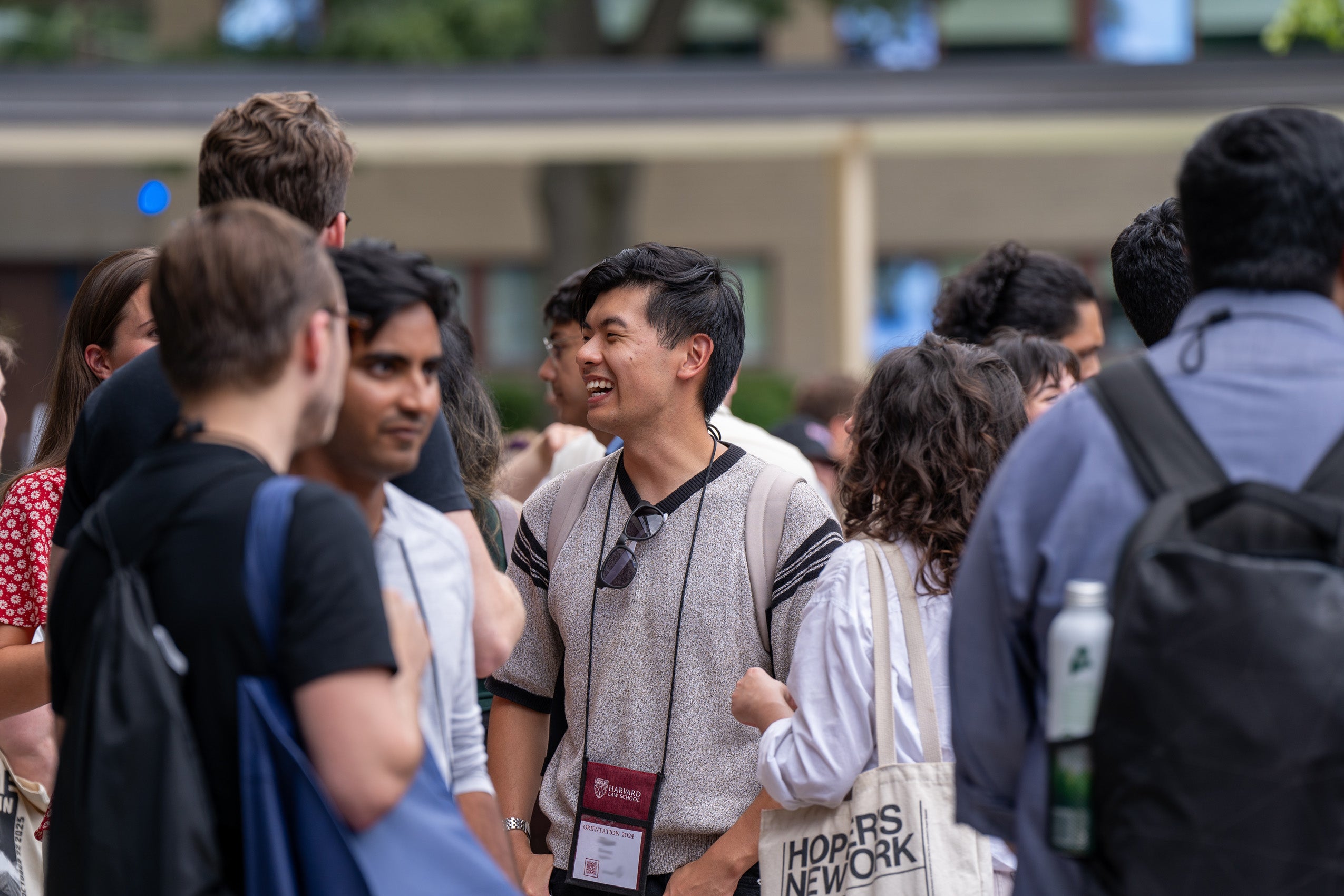 A student enjoys conversations with other students during an outside orientation event.
