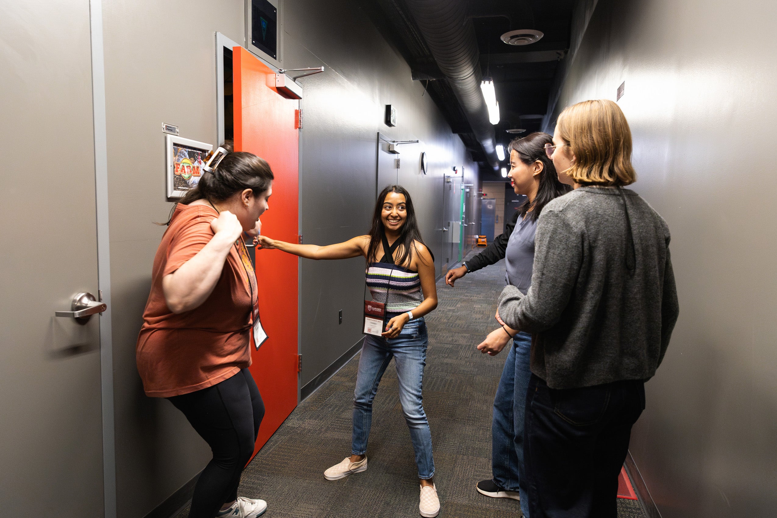 Students entering a game room at Boda Borg sign, an off campus game venue visited during orientation.