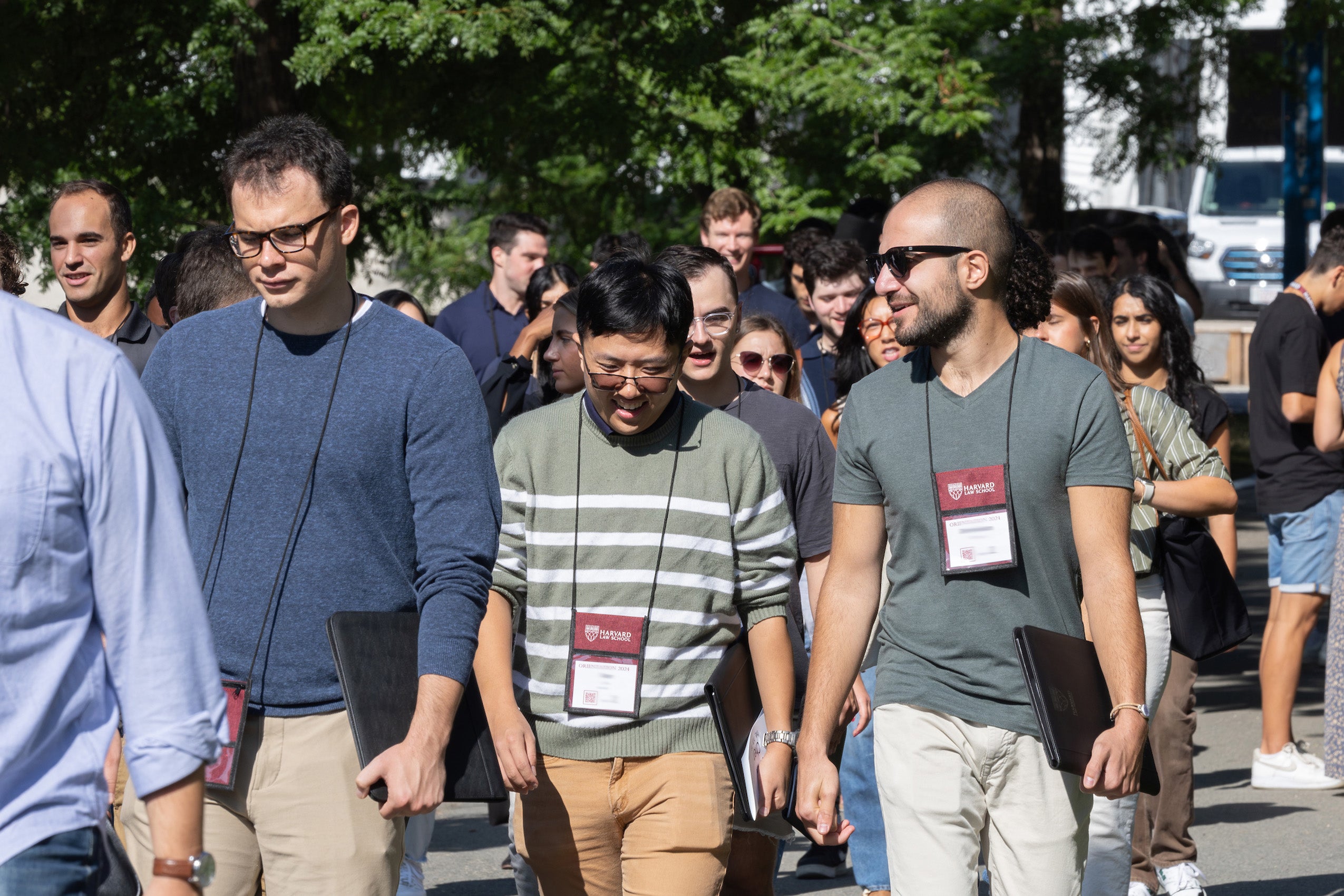 A group of students walking across campus during orientation.