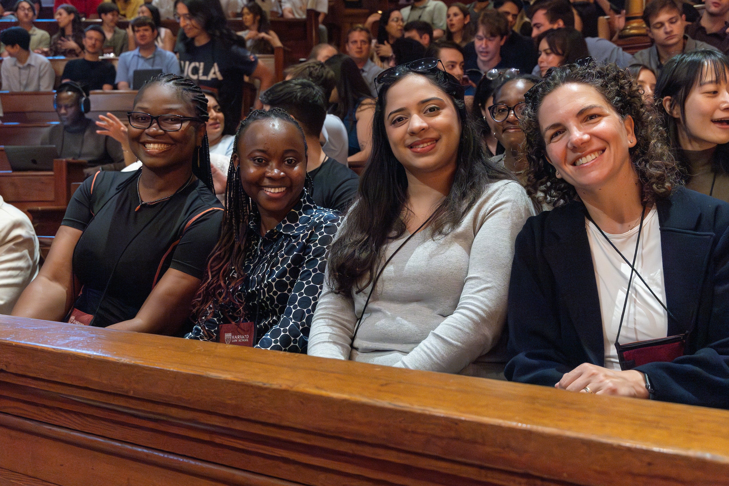 A row of four students post for the camera at an orientation event