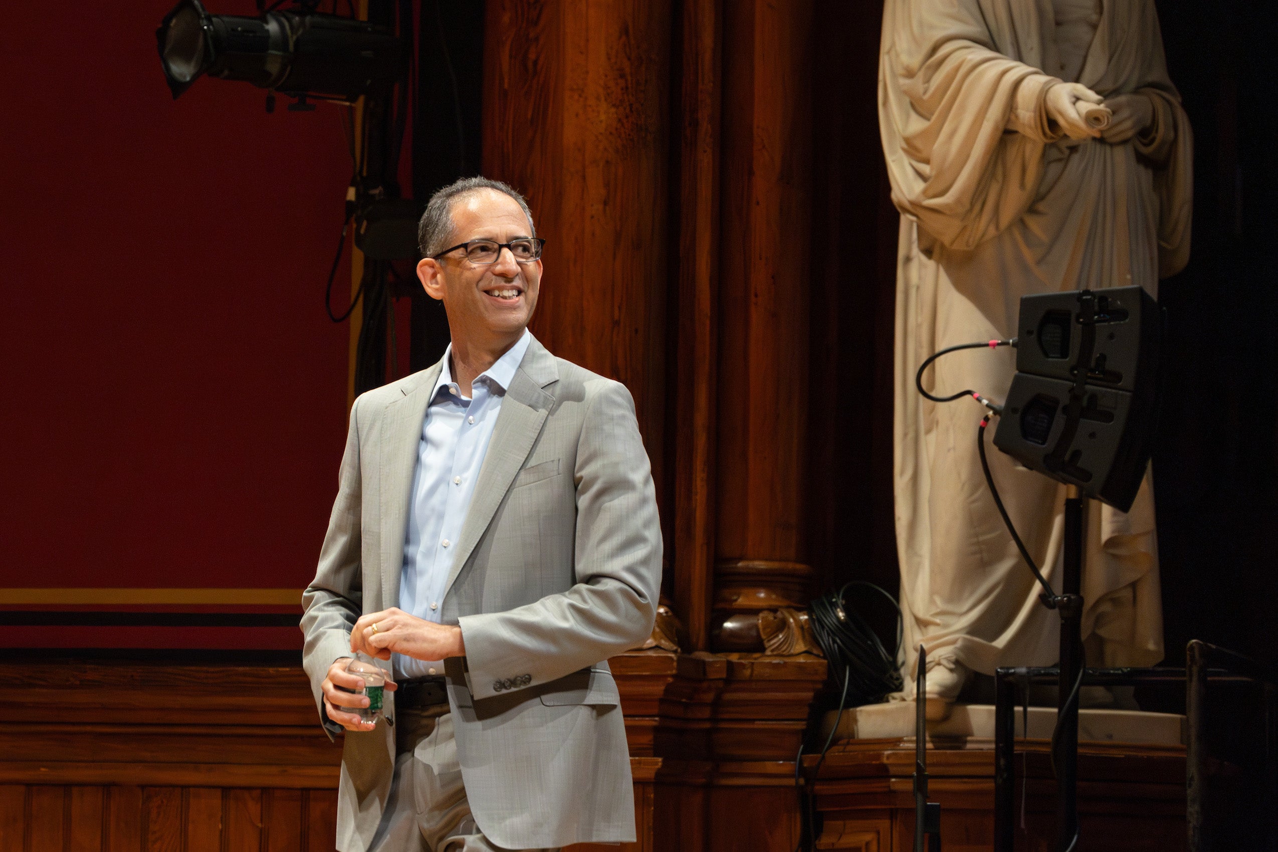 Dean Goldberg stands looking to his left on the stage of Sanders before giving remarks during orientation.