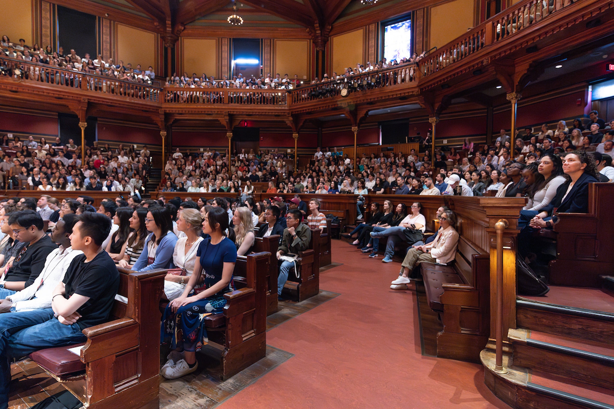 A view of students sitting in Sanders prior to the dean's remarks during orientation.