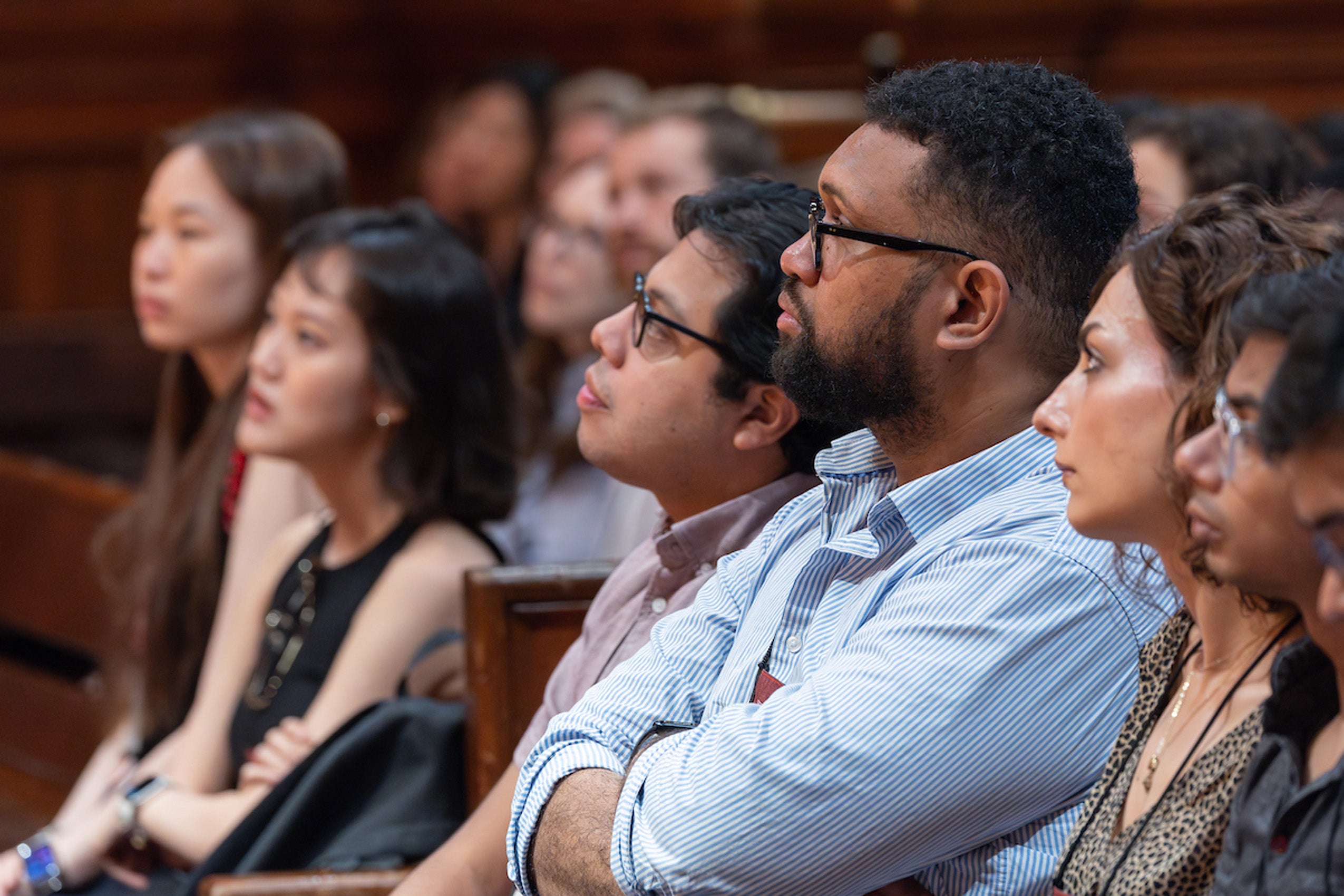 A row of students listening to remarks at an orientation event in Sanders.