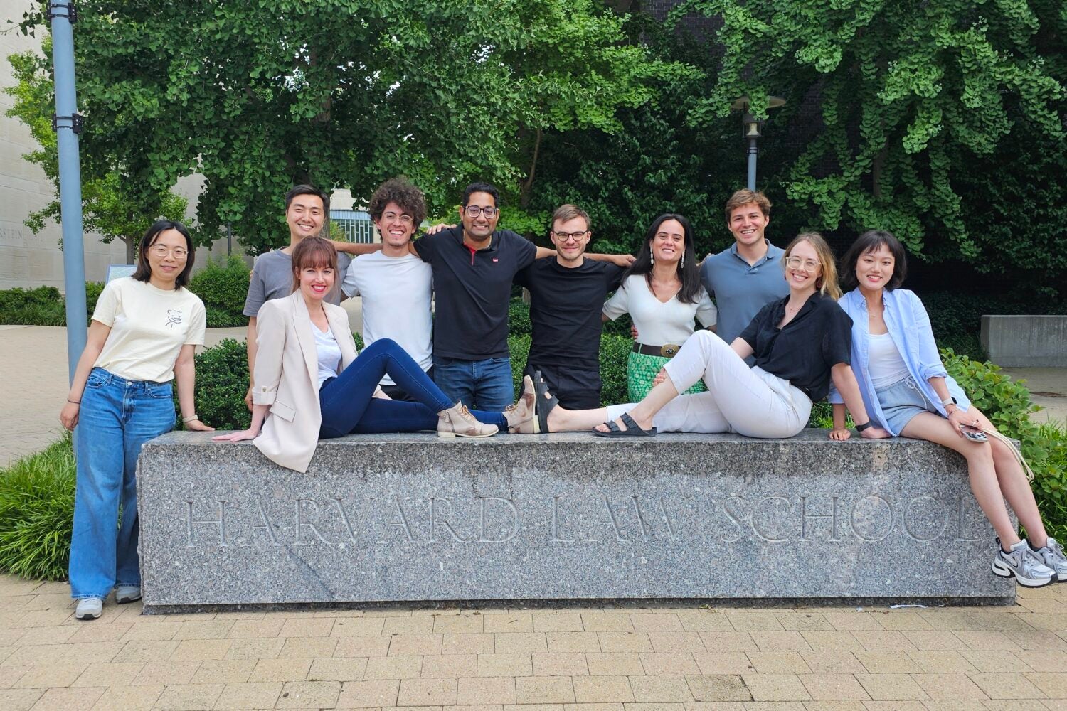 Students pose with the Harvard Law School sign