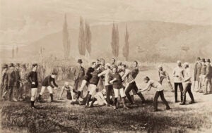 An historical illustration of a group of people on a field engaged in a football game