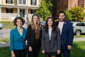 Stephanie Goldenhersh, Elizabeth Tuttle Newman, Erin Hegarty, and Jacob Chin pose for a photo in front of the Harvard Legal Aid Bureau.