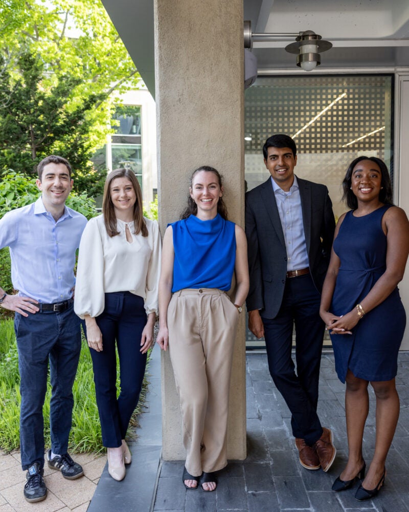 Five students standing under a doorway passage