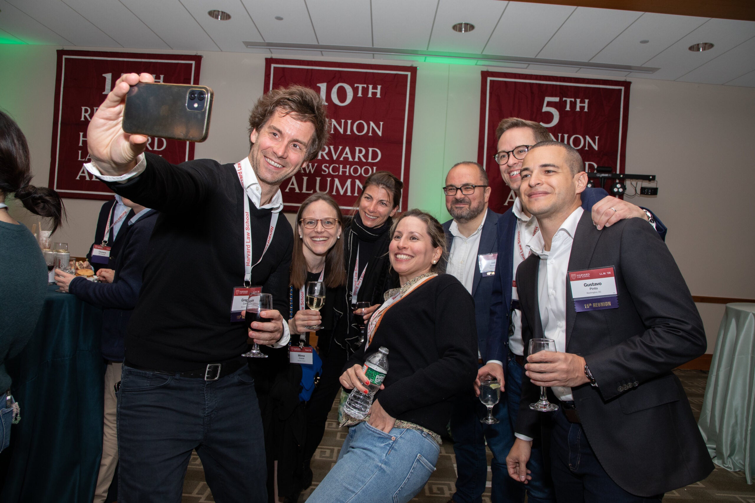 Harvard Law School alumni smiling for a picture together.