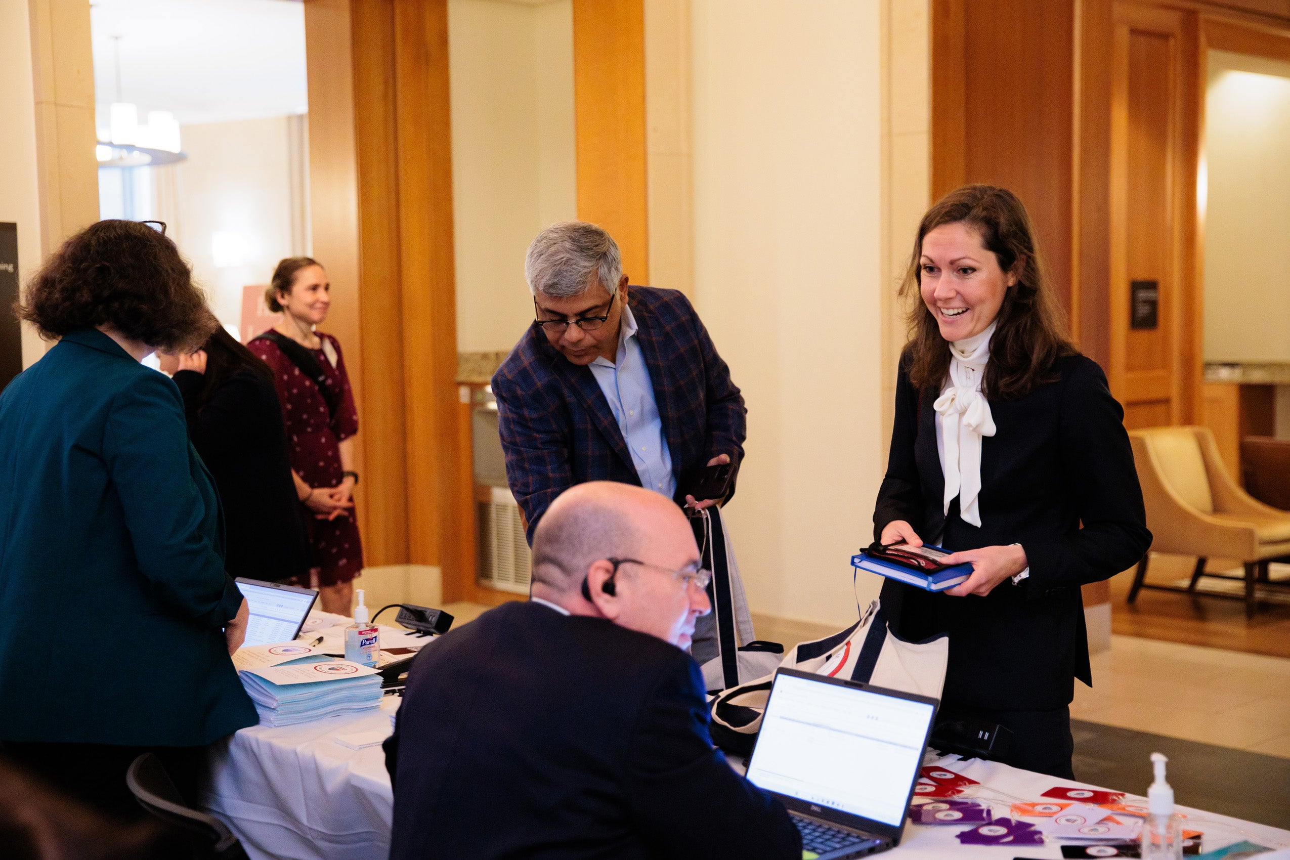 A woman stands at a table as she registers for an event