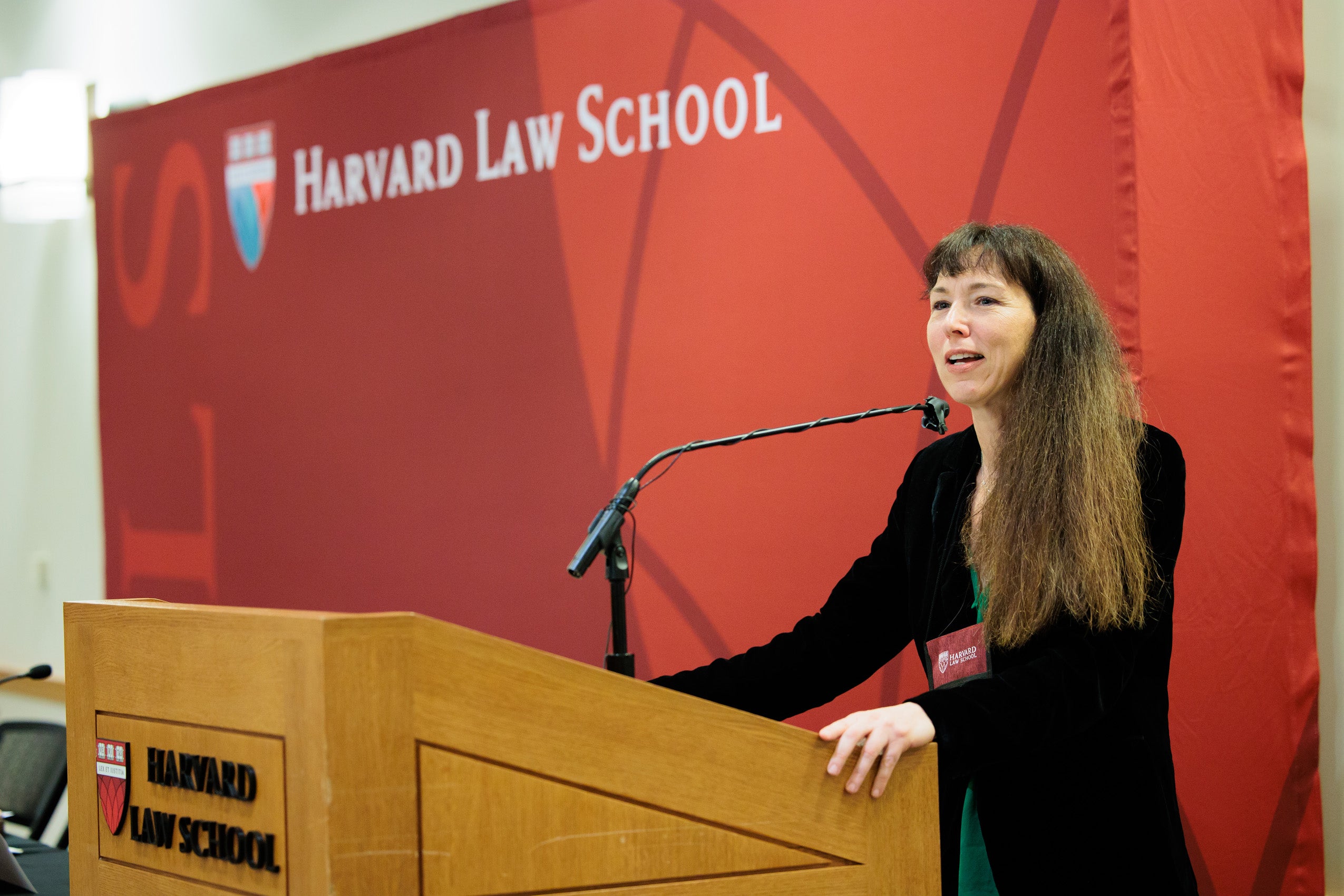 A woman speaks at a podium