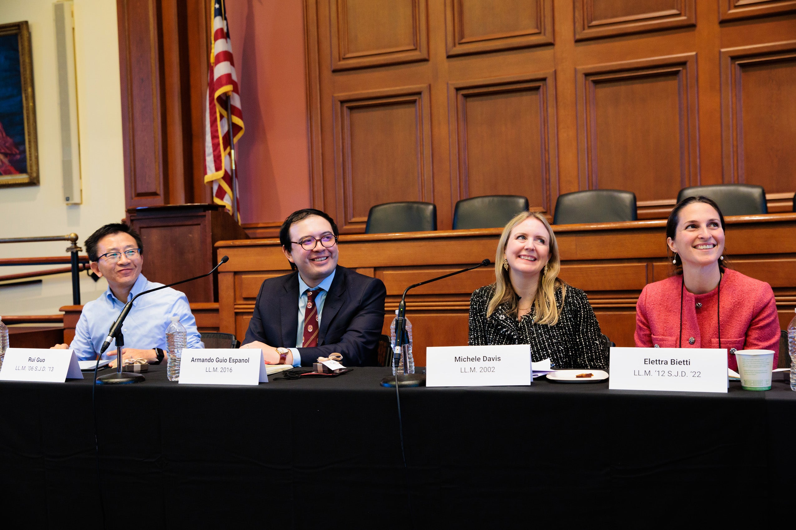 Two men and two women speak in a room on a panel