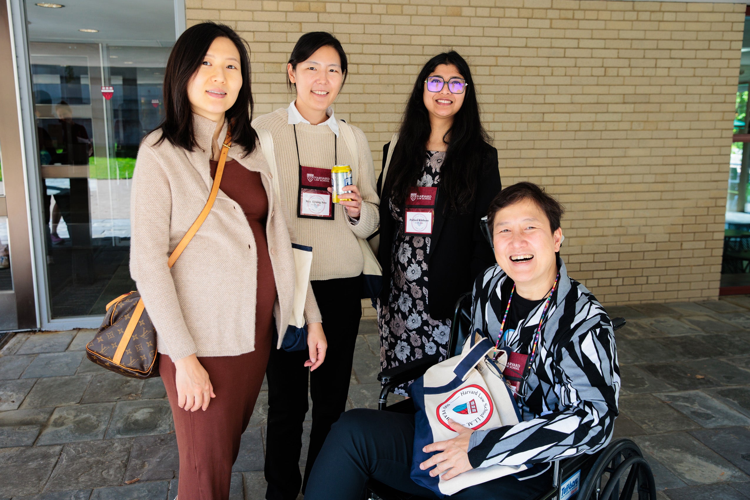 A group of four gathers outside a building