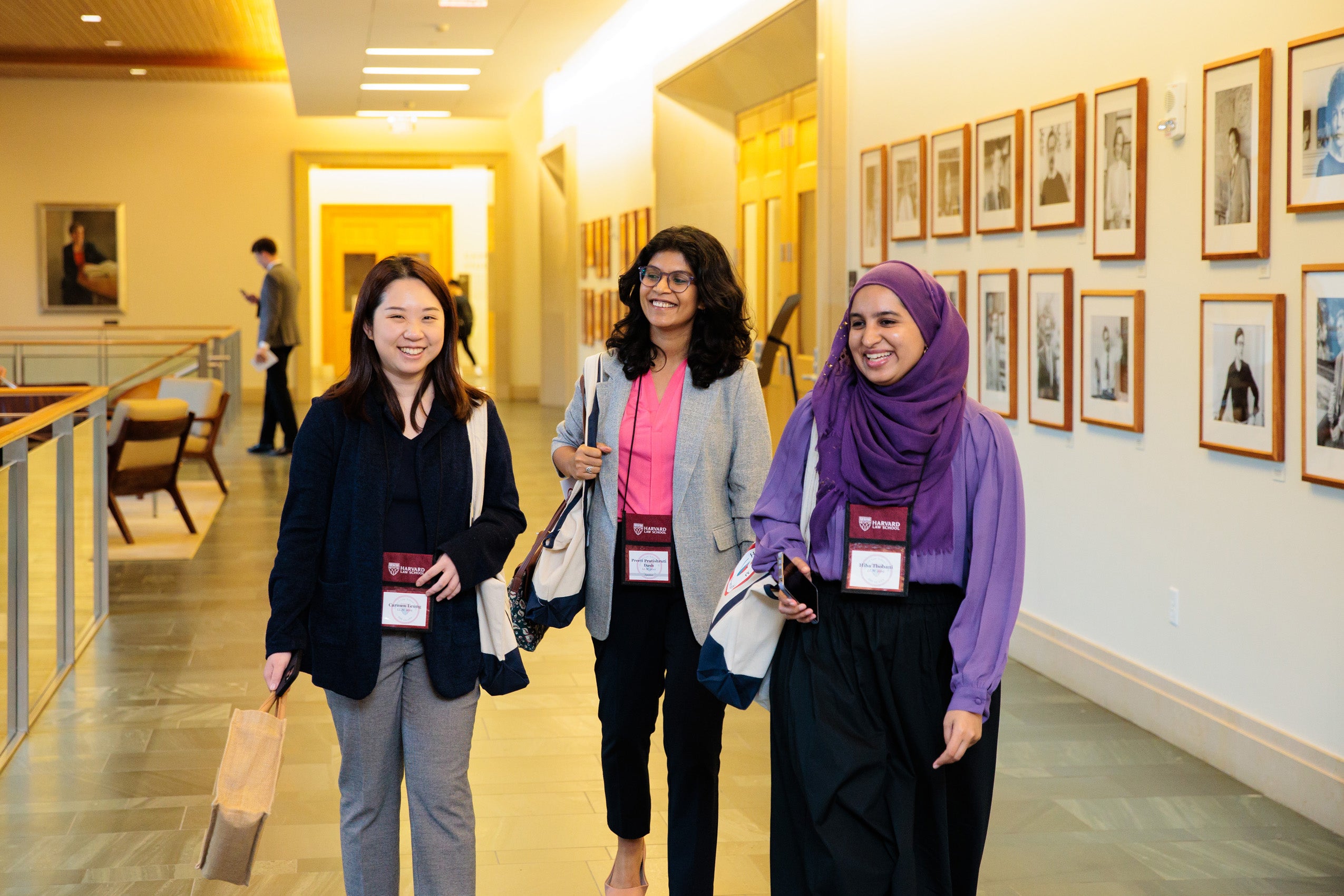 Three women walk down a hallway in the WCC