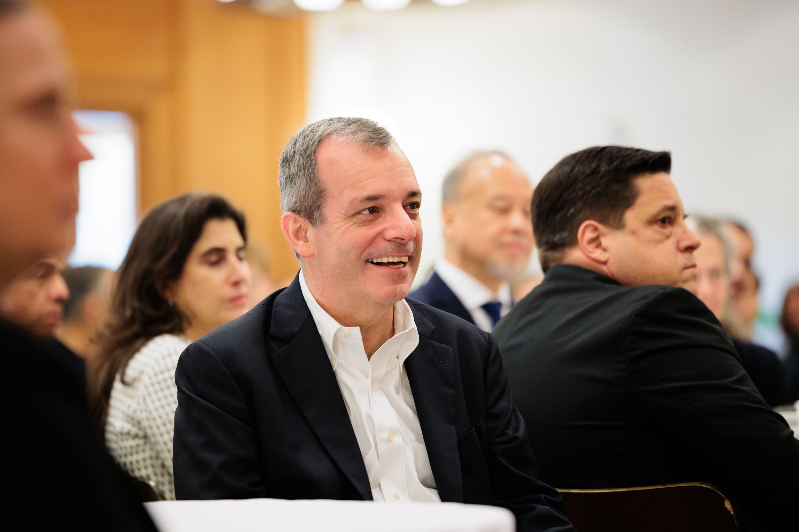 A close up of Provost Manning sitting in the audience of an event.