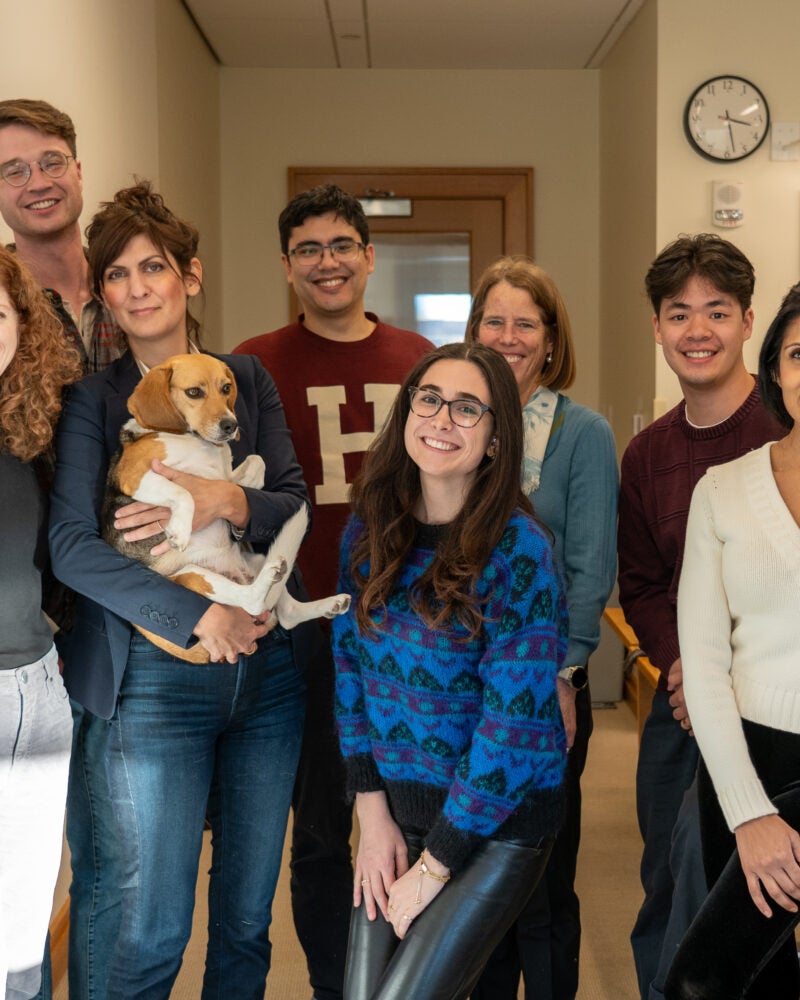 a group of students and instructors pose with a beagle