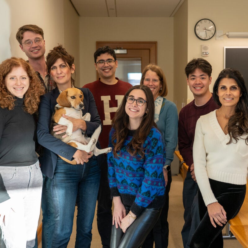 a group of students and instructors pose with a beagle