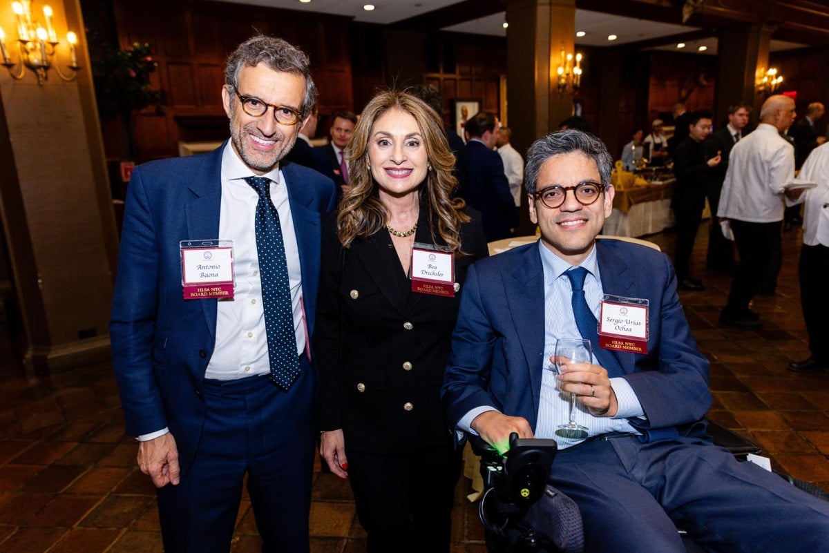 Three alumni posing for a photo