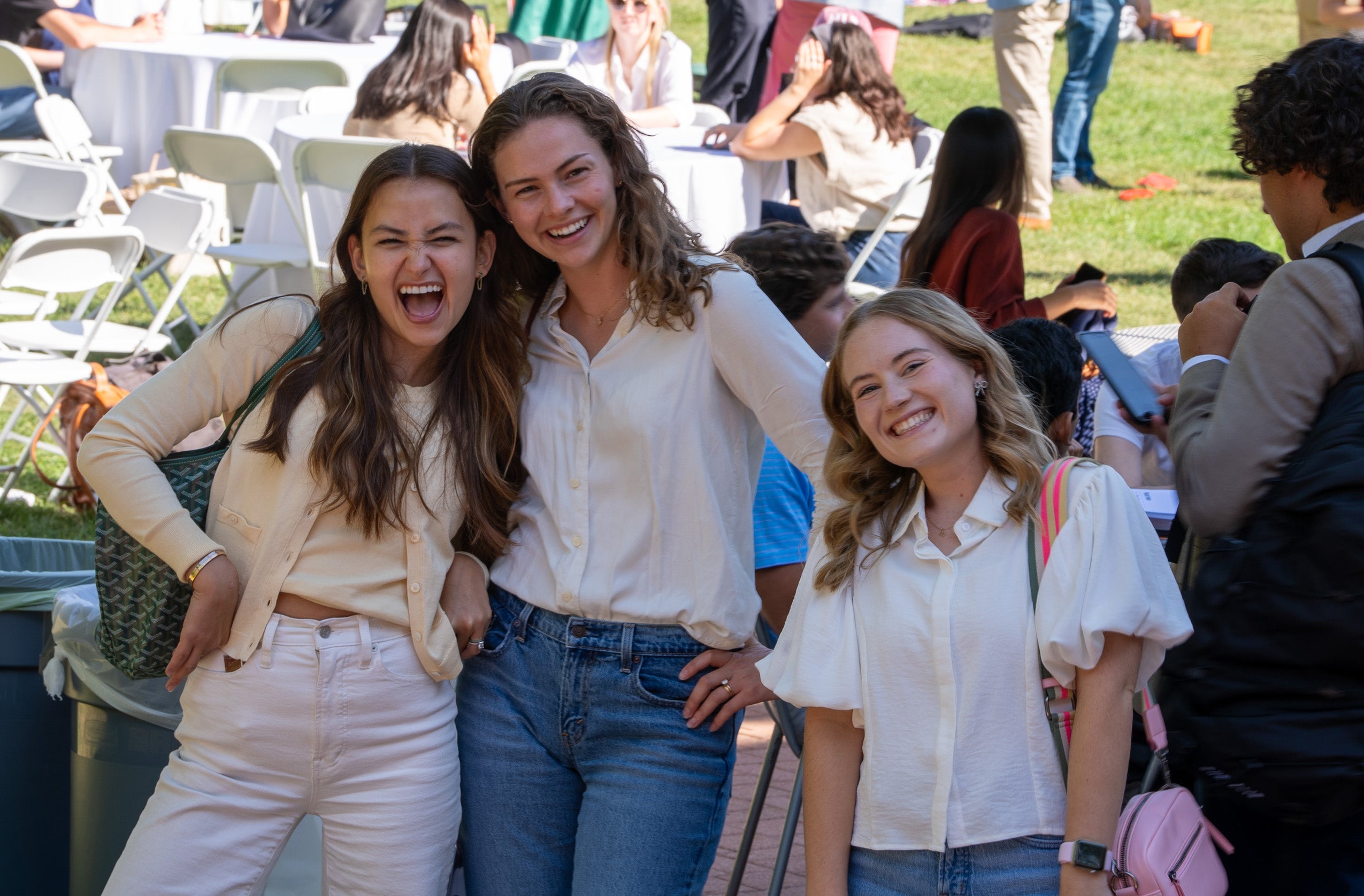 Three students pose for a photo at a campus event.