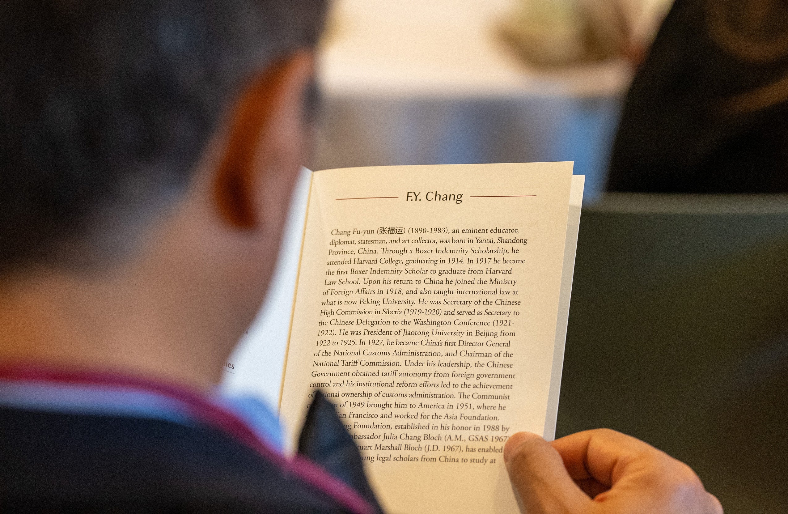 An over the shoulder look at at bio of F.Y. Chang in a program.